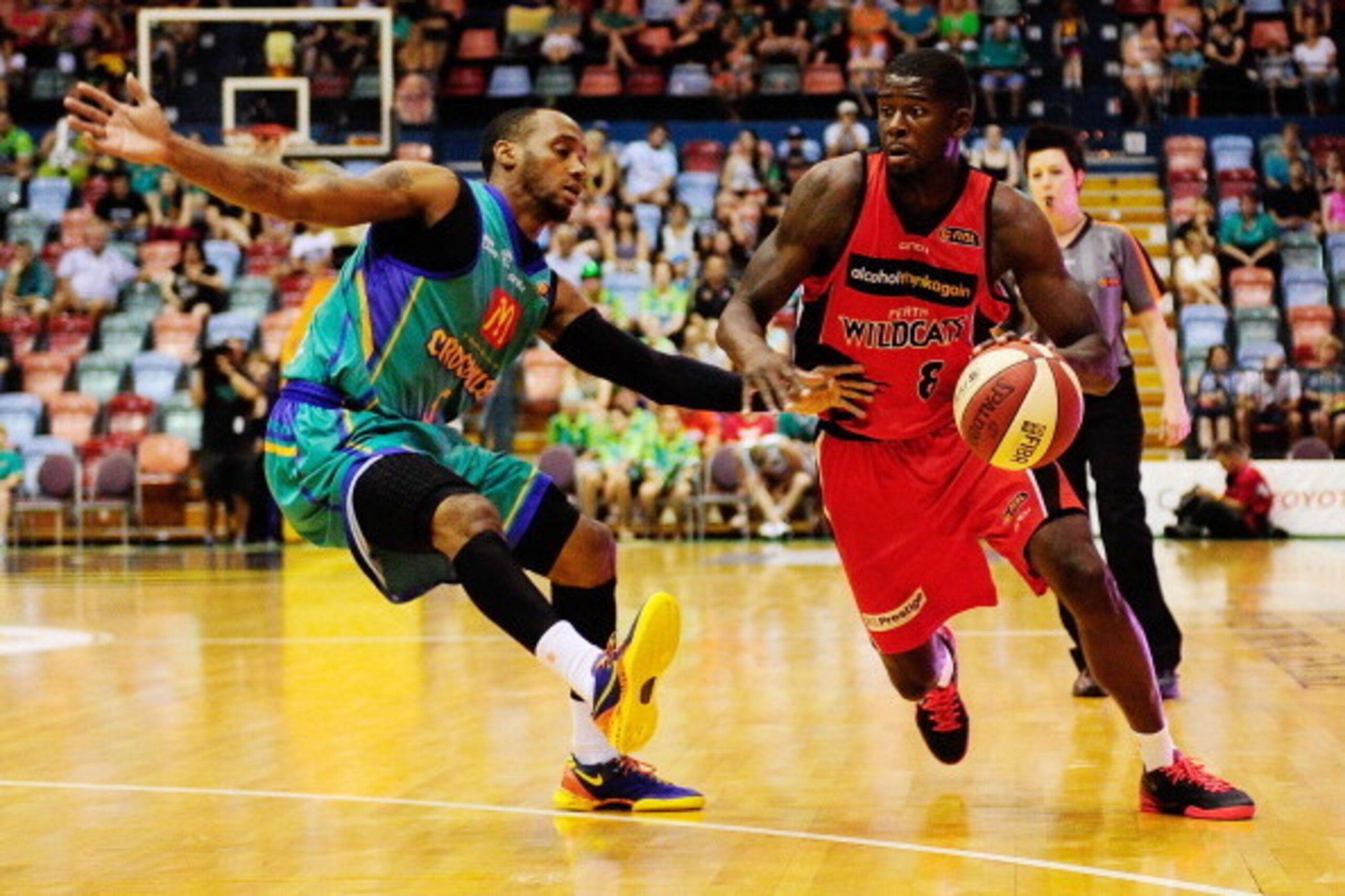 TOWNSVILLE, AUSTRALIA - JANUARY 12:  James Ennis of the Wildcats drives to the basket past Joshua Pace of the Crocodiles during the round 13 NBL match between the Townsville Crocodiles and the Perth Wildcats at Townsville Entertainment Centre in January 1