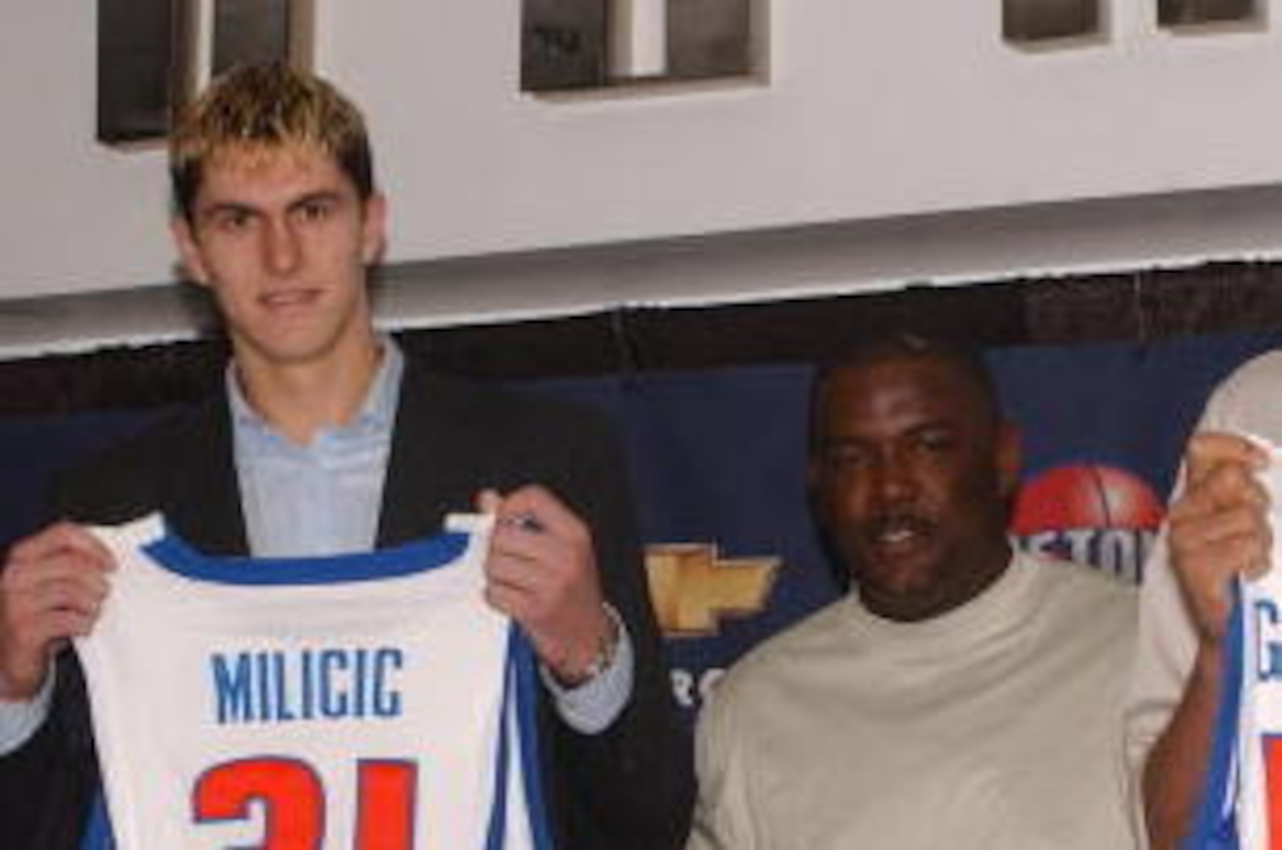 AUBURN HILLS, MI - JUNE 27: Detroit Pistons 2003 draft choices (L to R) Carlos Delfino, Darko Milicic and Andreas Glnniadakis display their new uniforms with Detroit Pistons president Joe Dumars (2nd R) at the Palace of Auburn Hills June 27, 2003 in Aubur AUBURN HILLS, MI - JUNE 27: Detroit Pistons 2003 draft choices (L to R) Carlos Delfino, Darko Milicic and Andreas Glnniadakis display their new uniforms with Detroit Pistons president Joe Dumars (2nd R) at the Palace of Auburn Hills June 27, 2003 in Aubur