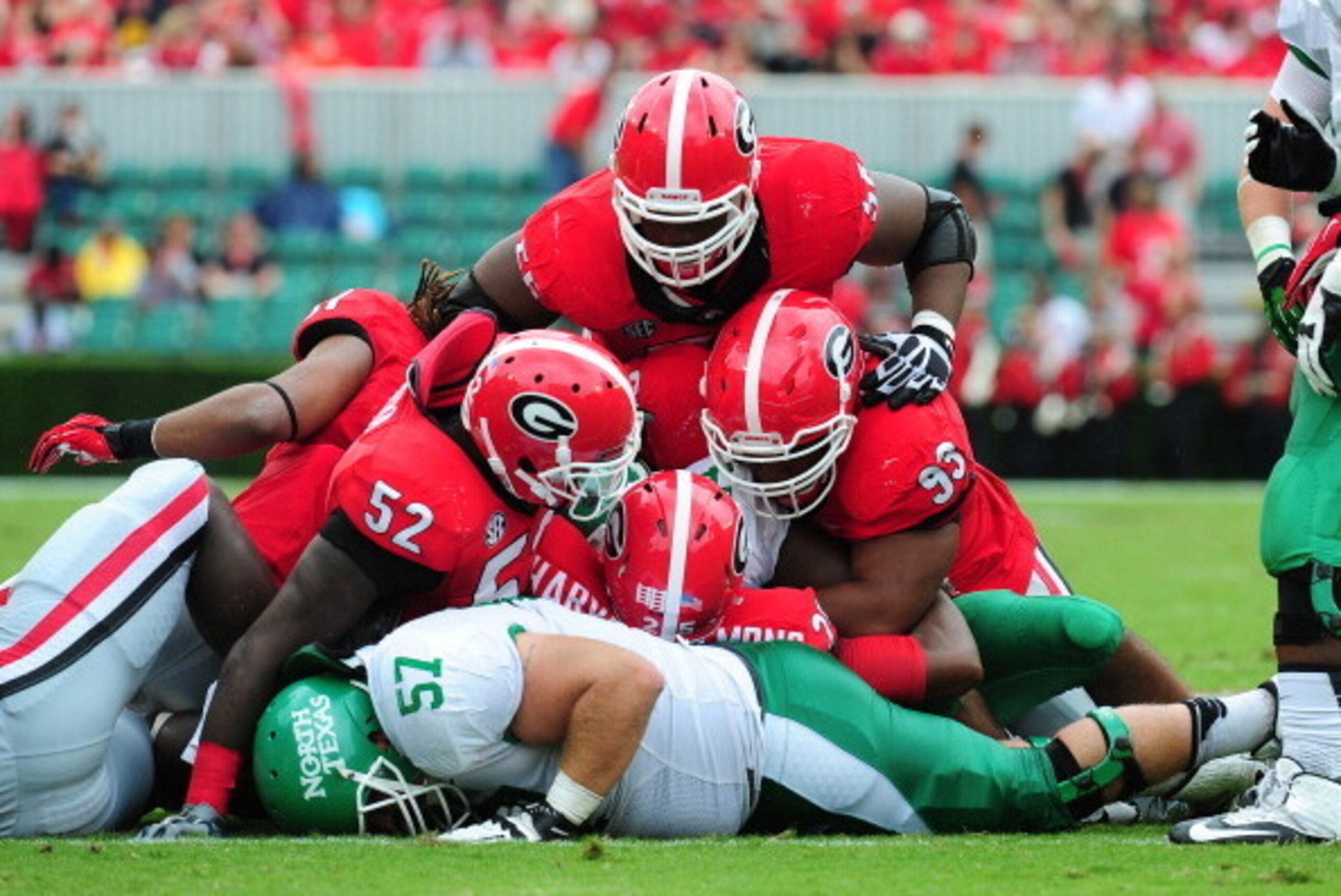 ATHENS, GA - SEPTEMBER 21: Brandin Byrd #24 and Mason Y'Barbo #57 of the North Texas Mean Green are buried by Chris Mayes #93, Amarlo Harrera #52, and Josh Harvey-Clemons #25 of the Georgia Bulldogs at Sanford Stadium on September 21, 2013 in Athens, Geor