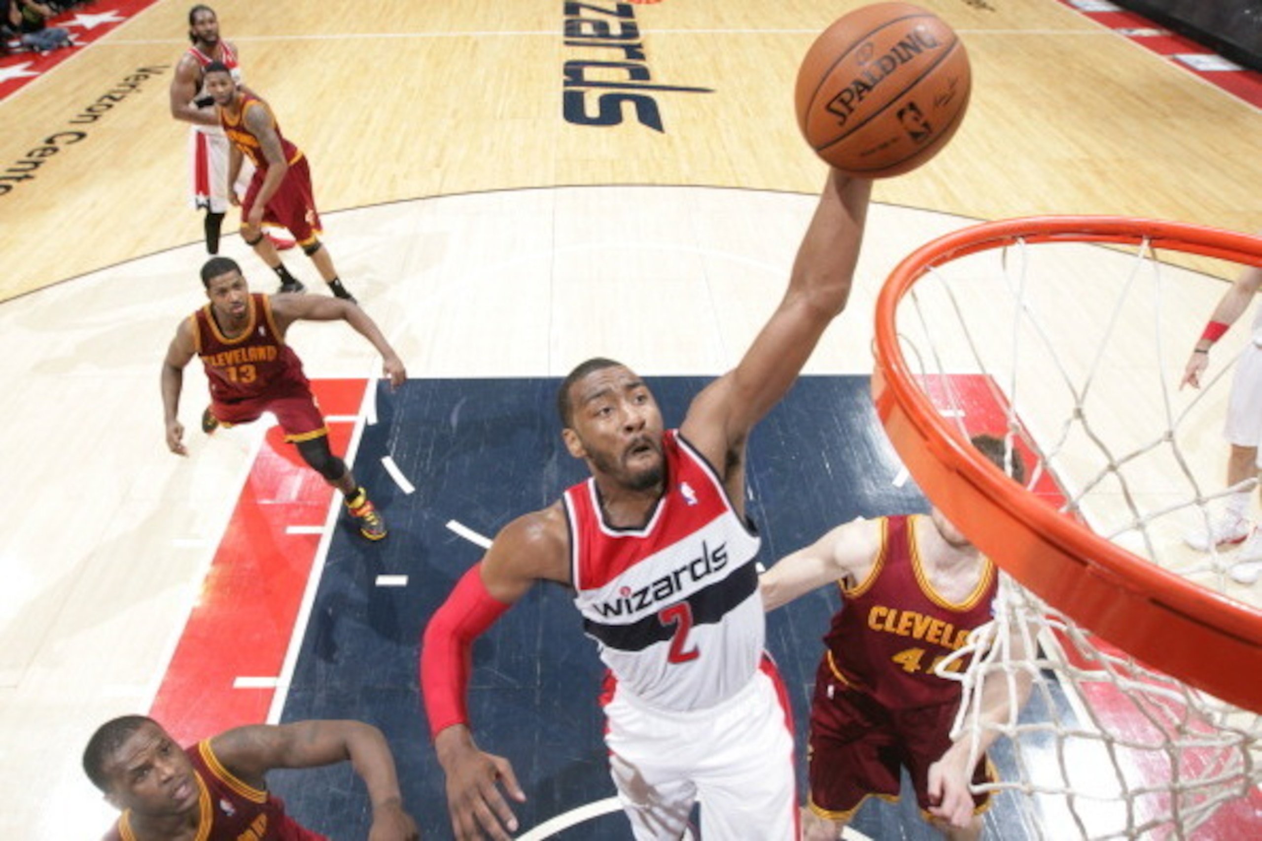 WASHINGTON, DC - FEBRUARY 7: John Wall #2 of the Washington Wizards dunks against Dion Waiters #3 and Tyler Zeller #40 of the Cleveland Cavaliers during the game at the Verizon Center on February 7, 2014 in Washington, DC. NOTE TO USER: User expressly ack