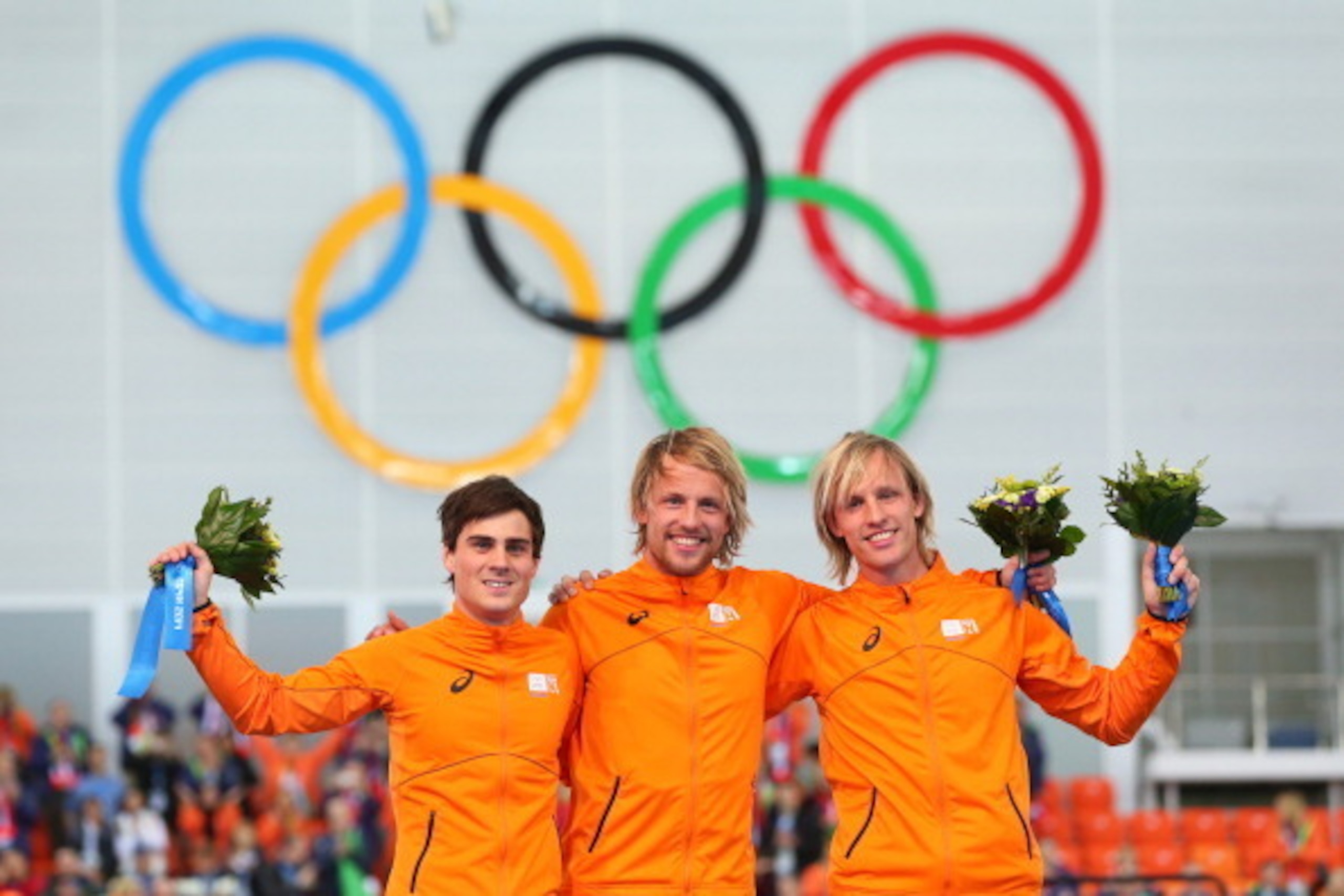 SOCHI, RUSSIA - FEBRUARY 10:  (L-R) Silver medalist Jan Smeekens of the Netherlands, gold medallist Michel Mulder of the Netherlands and bronze medalist Ronald Mulder of the Netherlands celebrate on the podium during the flower ceremony for the Men's 500m