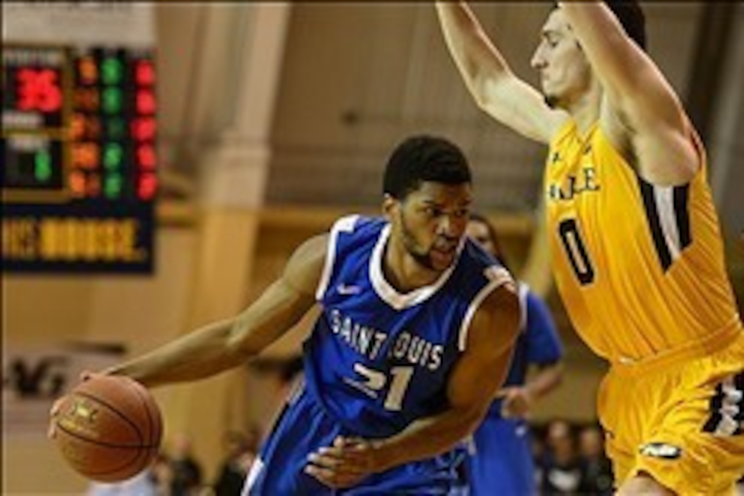 Feb 8, 2014; Philadelphia, PA, USA; Saint Louis Billikens forward Dwayne Evans (21) is defended by La Salle Explorers center Steve Zack (0) during the second half at Tom Gola Arena. St. Louis defeated La Salle 65-63. Mandatory Credit: Howard Smith-USA TOD