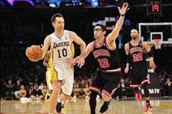 February 9, 2014; Los Angeles, CA, USA; Los Angeles Lakers point guard Steve Nash (10) controls the ball against Chicago Bulls shooting guard Kirk Hinrich (12) during the second half at Staples Center. Mandatory Credit: Gary A. Vasquez-USA TODAY Sports