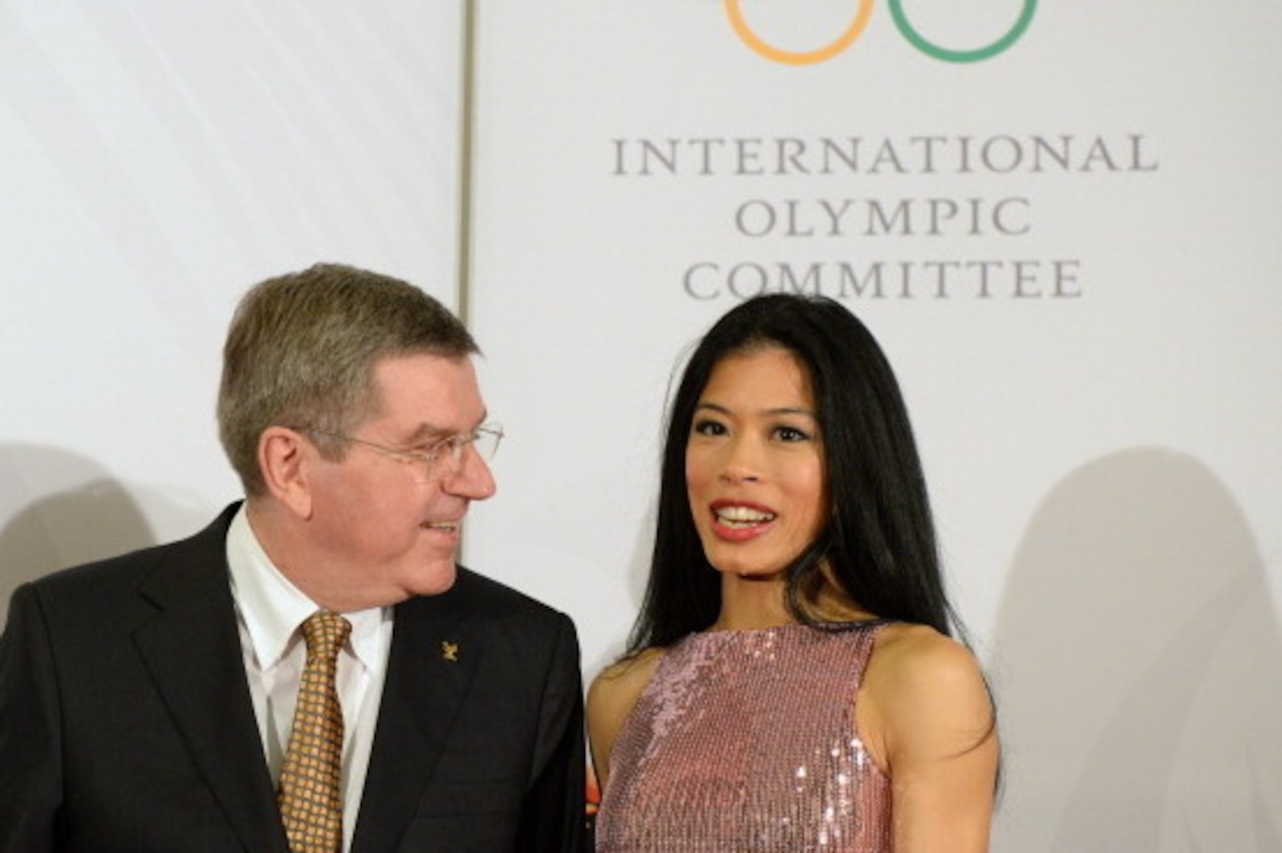 SOCHI, RUSSIA - FEBRUARY 06:  President of the International Olympic Committee (IOC), Thomas Bach (L) chats with former musician Vanessa-Mae, who will compete for Thailand as Alpine skier Vanessa Vanakorn, before the IOC Gala Dinner on the eve of the Soch