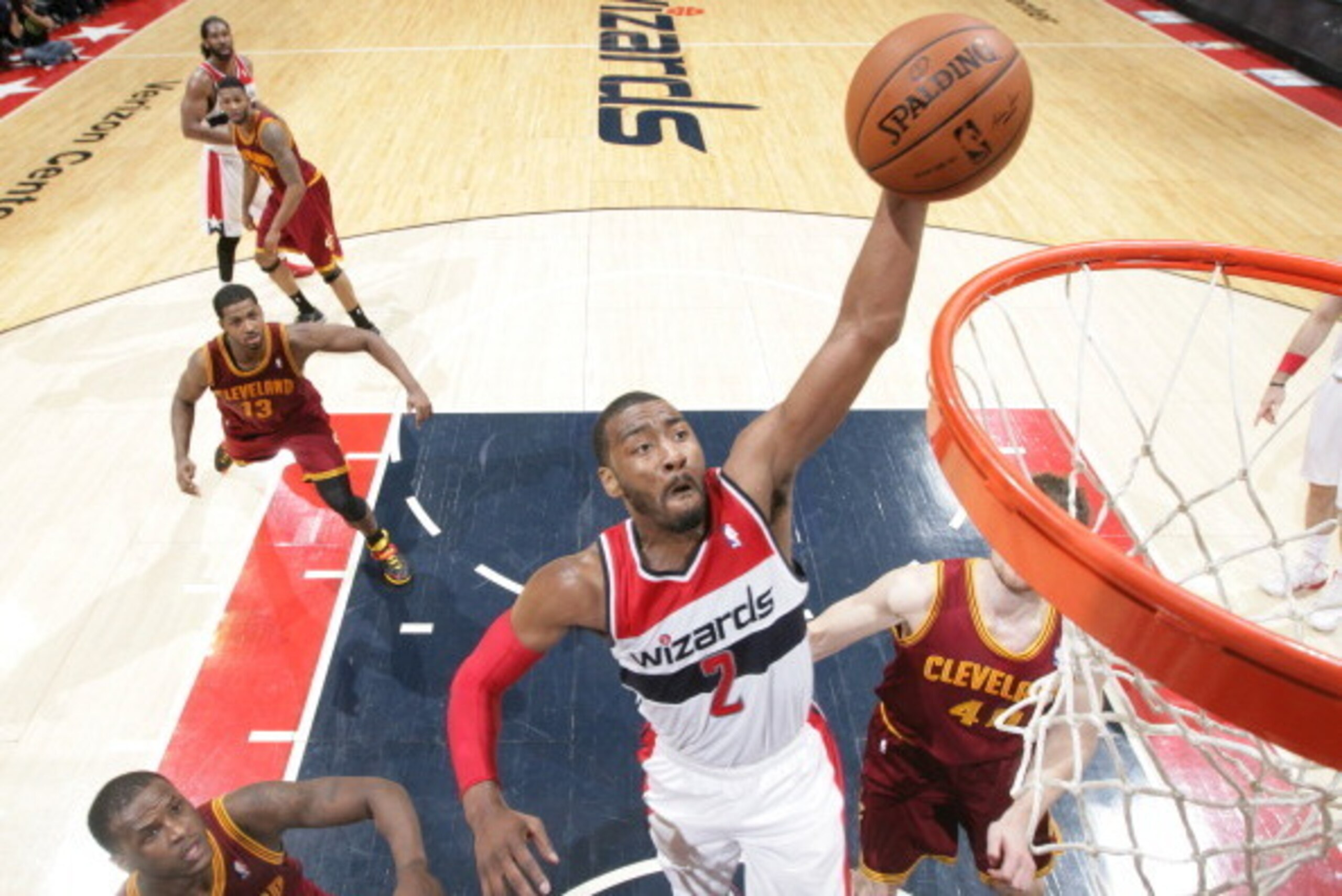 WASHINGTON, DC - FEBRUARY 7: John Wall #2 of the Washington Wizards dunks against Dion Waiters #3 and Tyler Zeller #40 of the Cleveland Cavaliers during the game at the Verizon Center on February 7, 2014 in Washington, DC. NOTE TO USER: User expressly ack