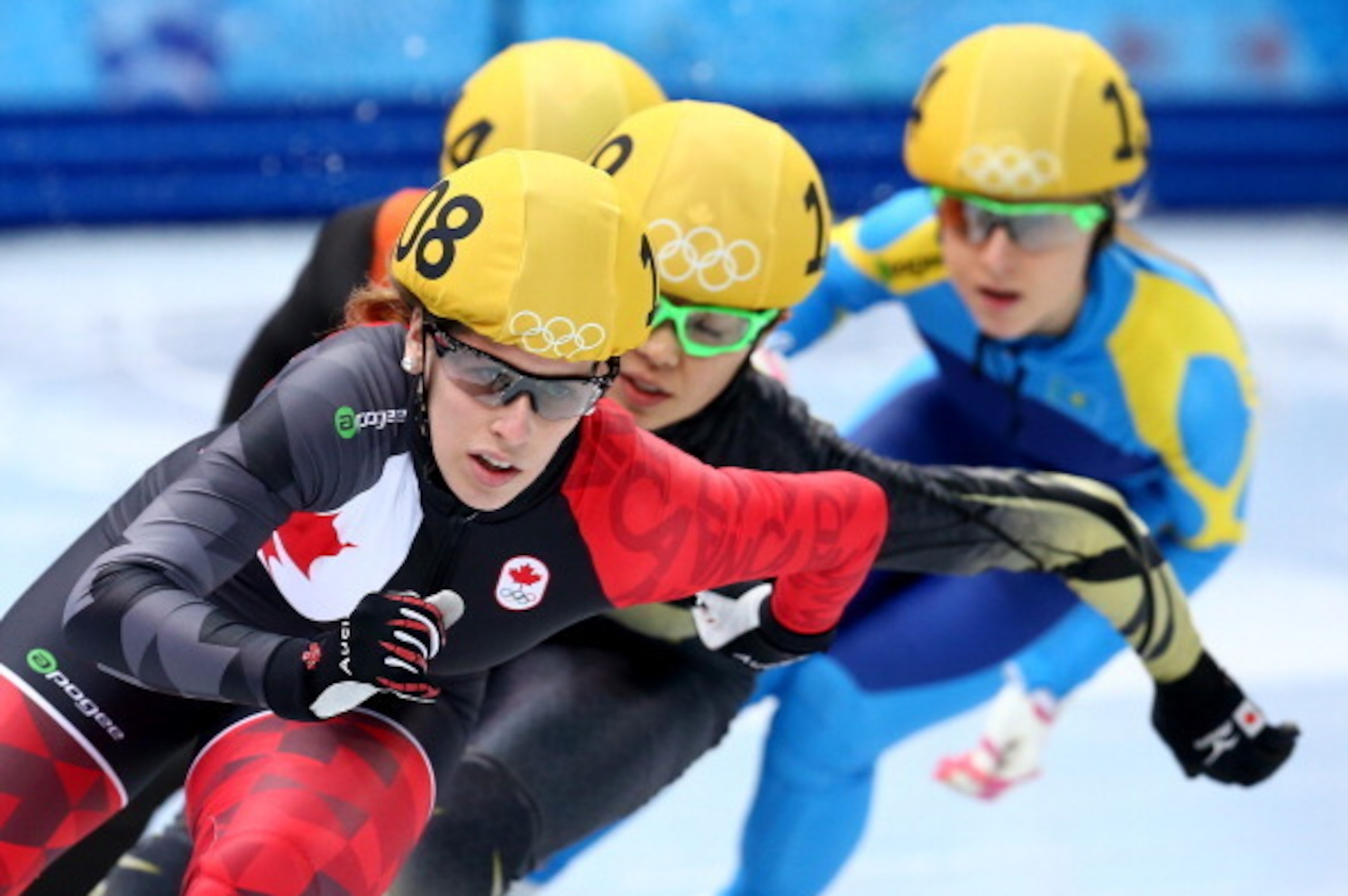 SOCHI, RUSSIA - FEBRUARY 10:  Marianne St-Gelais of Canada, Ayuko Ito of Japan and Inna Simonova of Kazakhstan compete in the Short Track Speed Skating Ladies' 500m heats on day 3 of the Sochi 2014 Winter Olympics at Iceberg Skating Palace on February 10,