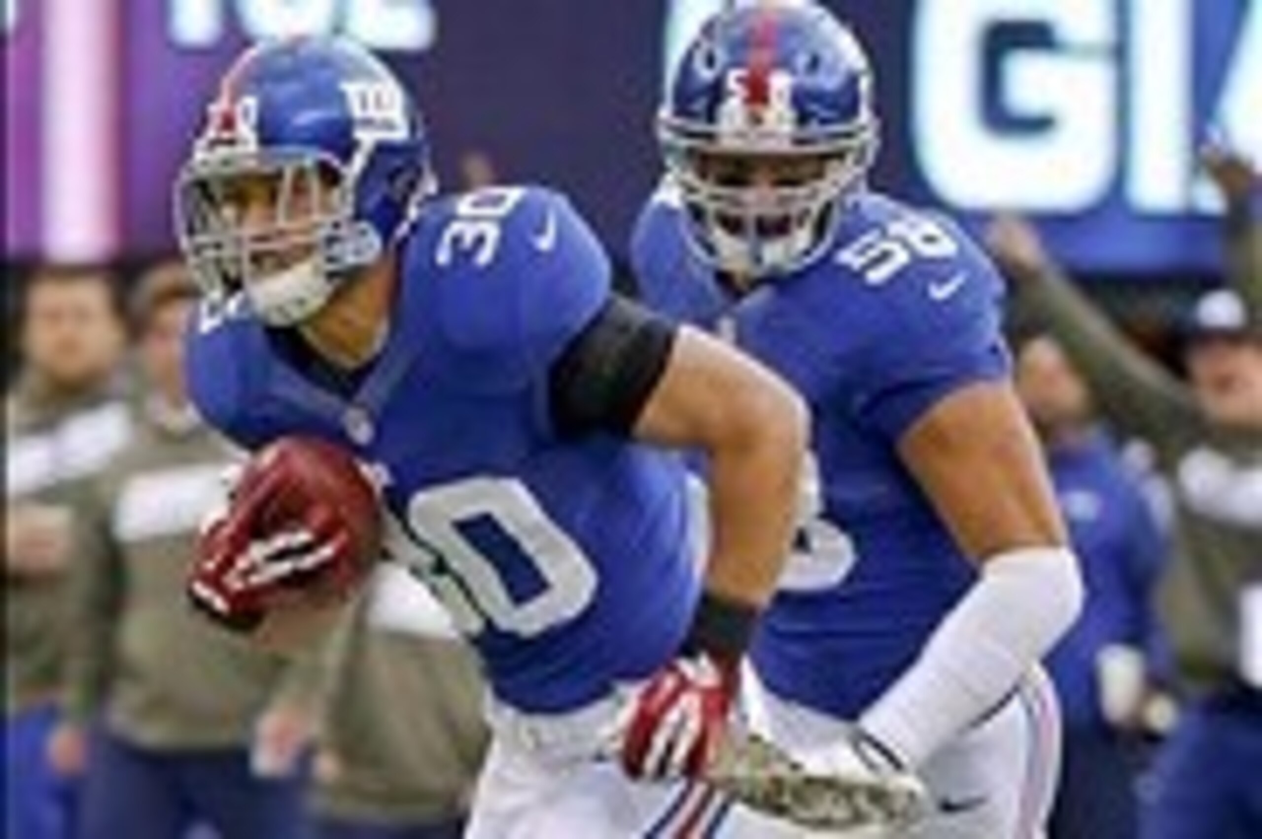 Nov 10, 2013; East Rutherford, NJ, USA;  New York Giants safety Cooper Taylor (30) runs in blocked punt for touchdown during the first half against the Oakland Raiders at MetLife Stadium. Mandatory Credit: Jim O'Connor-USA TODAY Sports