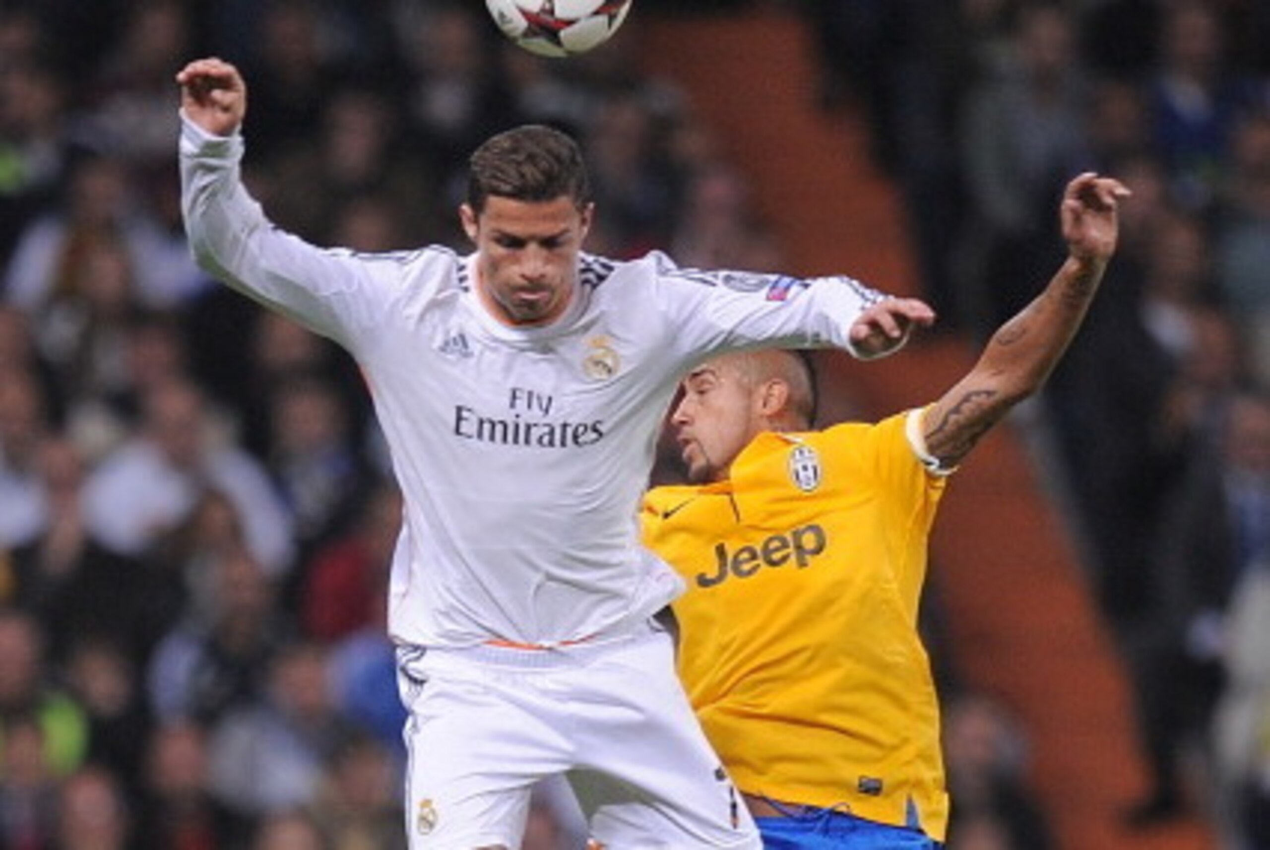 MADRID, SPAIN - OCTOBER 23: Cristiano Ronaldo (L) of Real Madrid CF goes for a high ball against Arturo Vidal
of Juventus during the UEFA Champions League Group B match between Real Madrid CF and Juventus at Estadio Santiago Bernabeu on October 23, 2013 MADRID, SPAIN - OCTOBER 23: Cristiano Ronaldo (L) of Real Madrid CF goes for a high ball against Arturo Vidal
of Juventus during the UEFA Champions League Group B match between Real Madrid CF and Juventus at Estadio Santiago Bernabeu on October 23, 2013