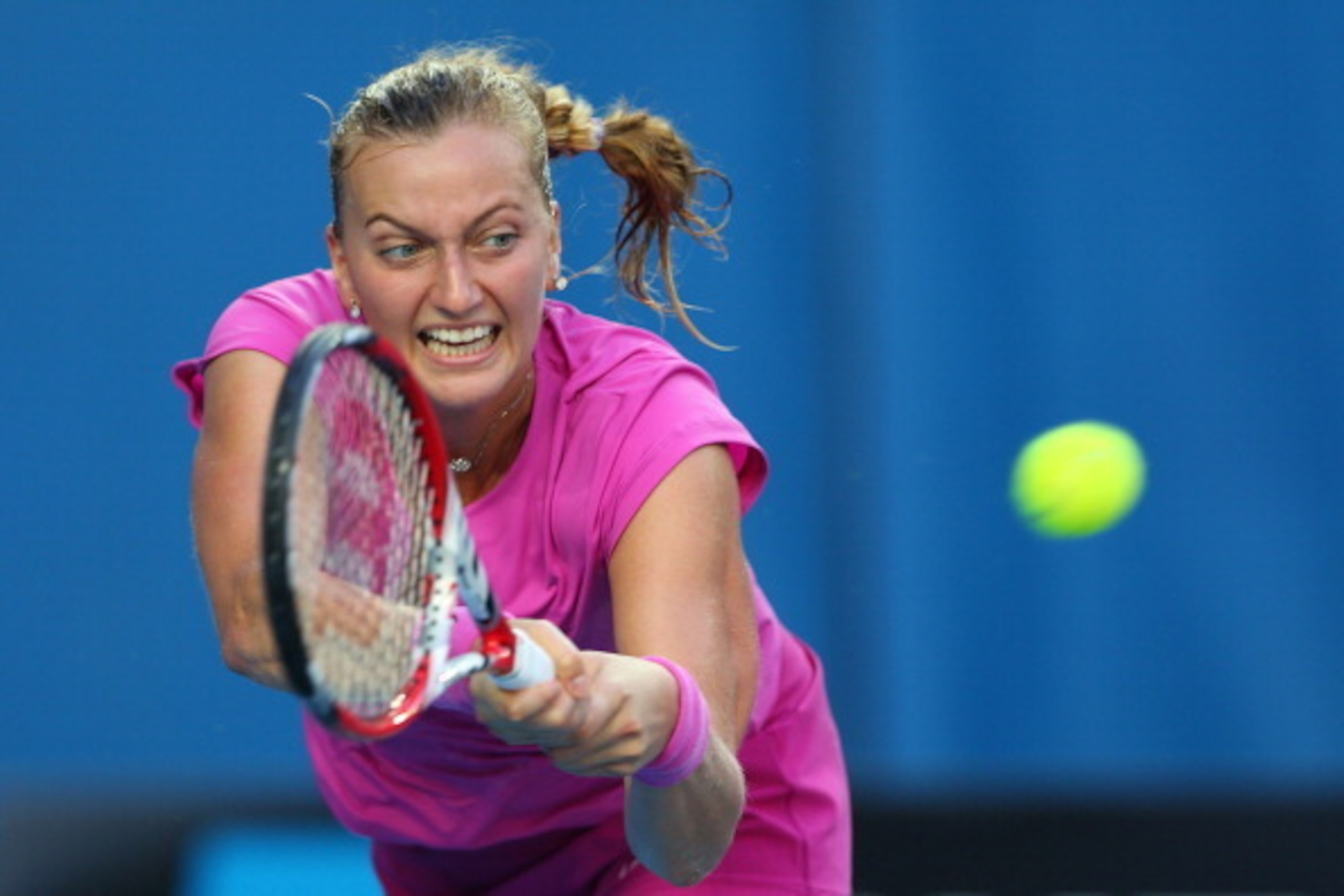 MELBOURNE, AUSTRALIA - JANUARY 13:  Petra Kvitova of the Czech Republic plays a forehand in her first round match against Luksika Kumkhum of Thailand during day one of the 2014 Australian Open at Melbourne Park on January 13, 2014 in Melbourne, Australia.