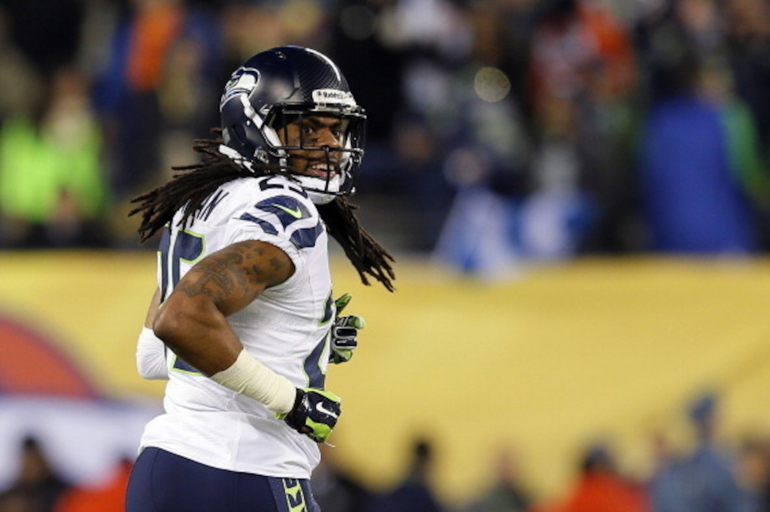 EAST RUTHERFORD, NJ - FEBRUARY 02:  Cornerback Richard Sherman #25 of the Seattle Seahawks smiles after his teammate outside linebacker Malcolm Smith #53 scored a 69-yard touchdown in the second quarter during Super Bowl XLVIII at MetLife Stadium on Febru