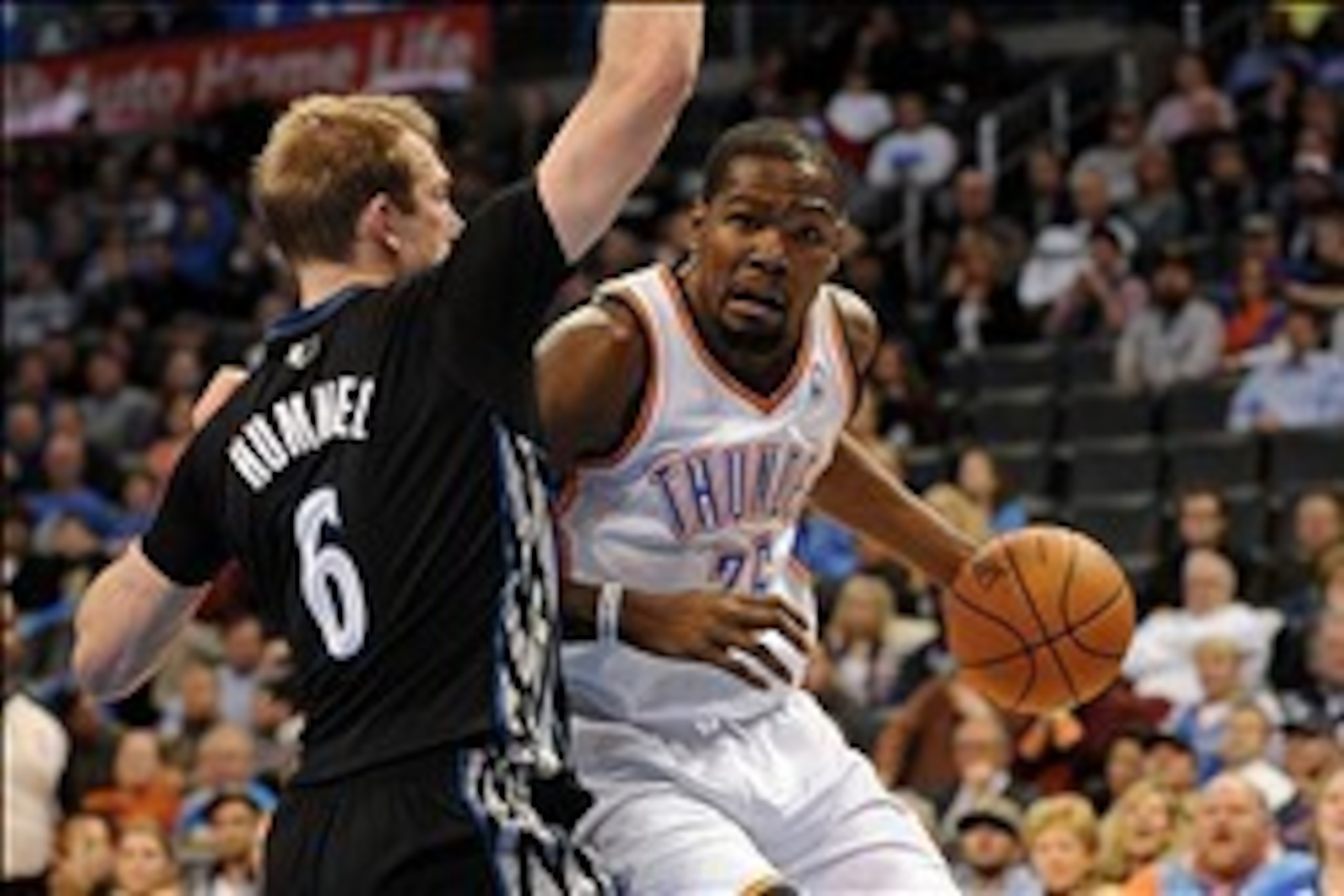 Feb 5, 2014; Oklahoma City, OK, USA; Oklahoma City Thunder small forward Kevin Durant (35) dribbles the ball around Minnesota Timberwolves small forward Robbie Hummel (6) during the fourth quarter at Chesapeake Energy Arena. Mandatory Credit: Mark D. Smit