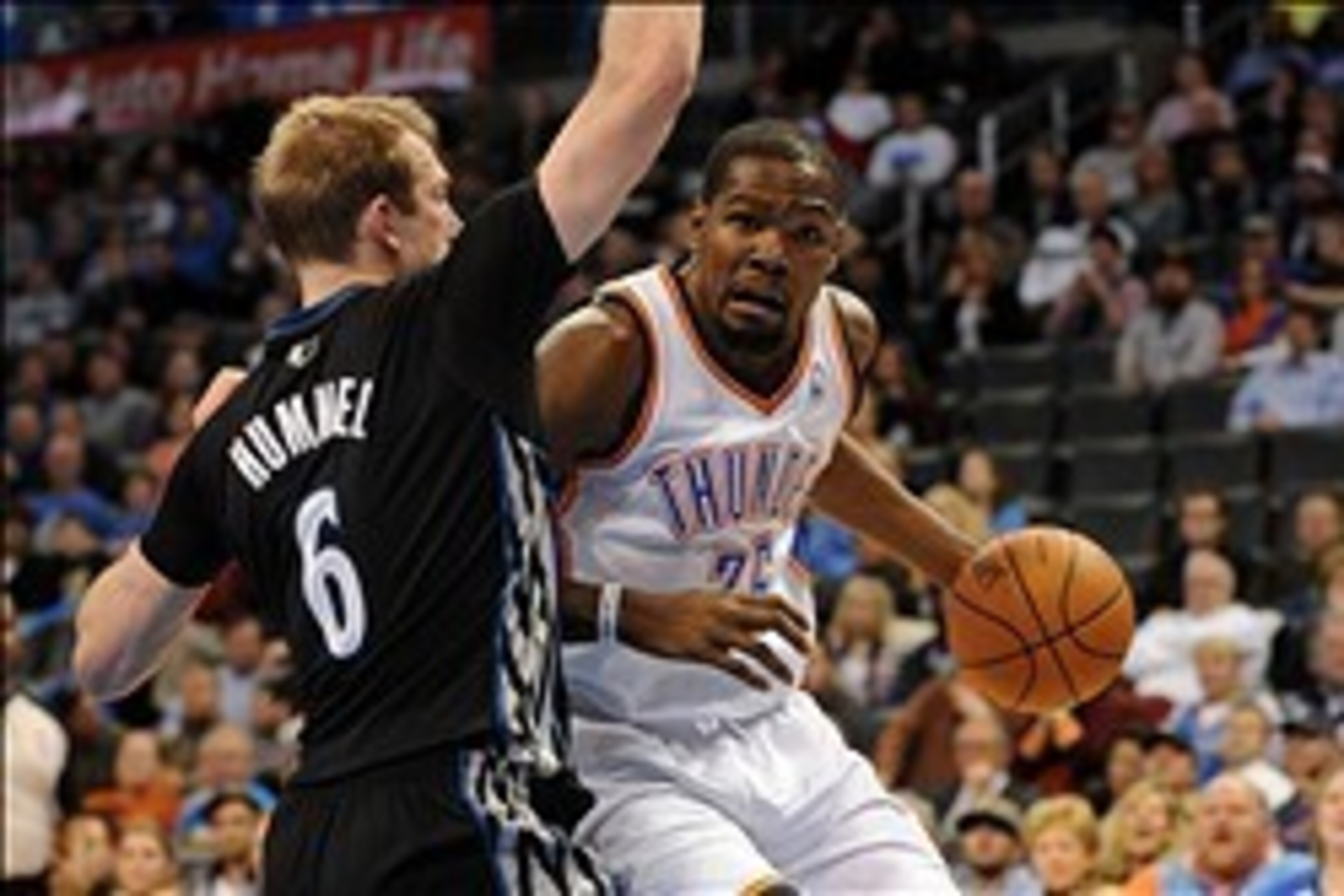 Feb 5, 2014; Oklahoma City, OK, USA; Oklahoma City Thunder small forward Kevin Durant (35) dribbles the ball around Minnesota Timberwolves small forward Robbie Hummel (6) during the fourth quarter at Chesapeake Energy Arena. Mandatory Credit: Mark D. Smit