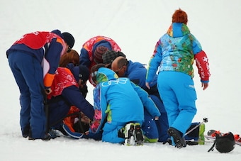 SOCHI, RUSSIA - FEBRUARY 11:  Yuki Tsubota of Canada is helped by medical service workers after a crash in the Freestyle Skiing Women's Ski Slopestyle Finals on day four of the Sochi 2014 Winter Olympics at Rosa Khutor Extreme Park on February 11, 2014 in
