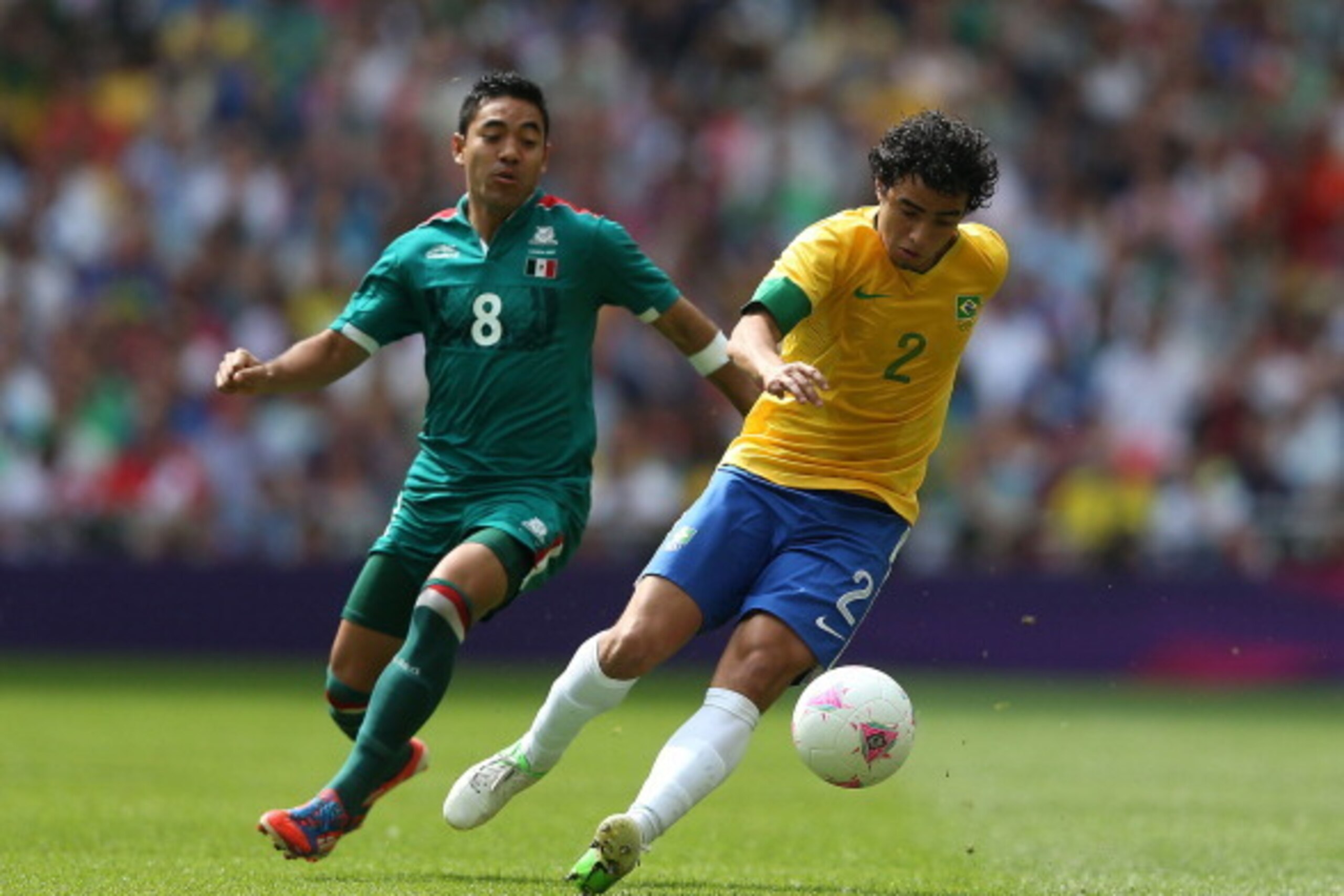 LONDON, ENGLAND - AUGUST 11: Marco Fabian of Mexico (L) competes for the ball with Rafael of Brazil during the Men's Football Final between Brazil and Mexico on Day 15 of the London 2012 Olympic Games at Wembley Stadium on August 11, 2012 in London, Engla