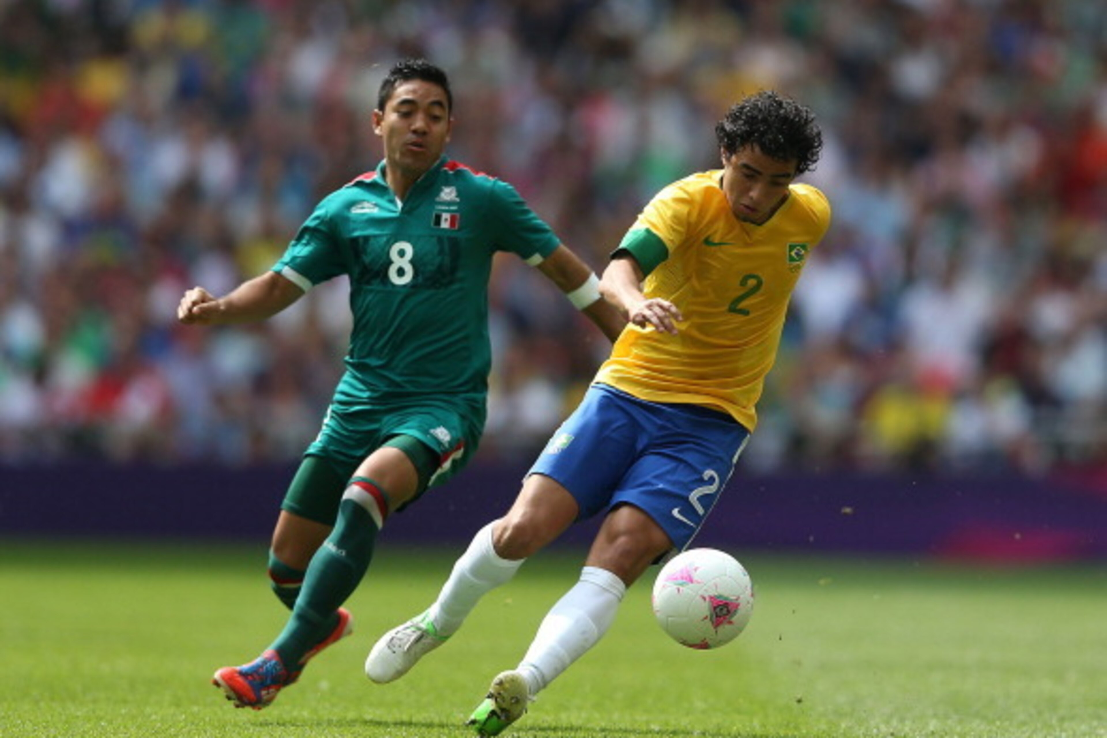 LONDON, ENGLAND - AUGUST 11: Marco Fabian of Mexico (L) competes for the ball with Rafael of Brazil during the Men's Football Final between Brazil and Mexico on Day 15 of the London 2012 Olympic Games at Wembley Stadium on August 11, 2012 in London, Engla