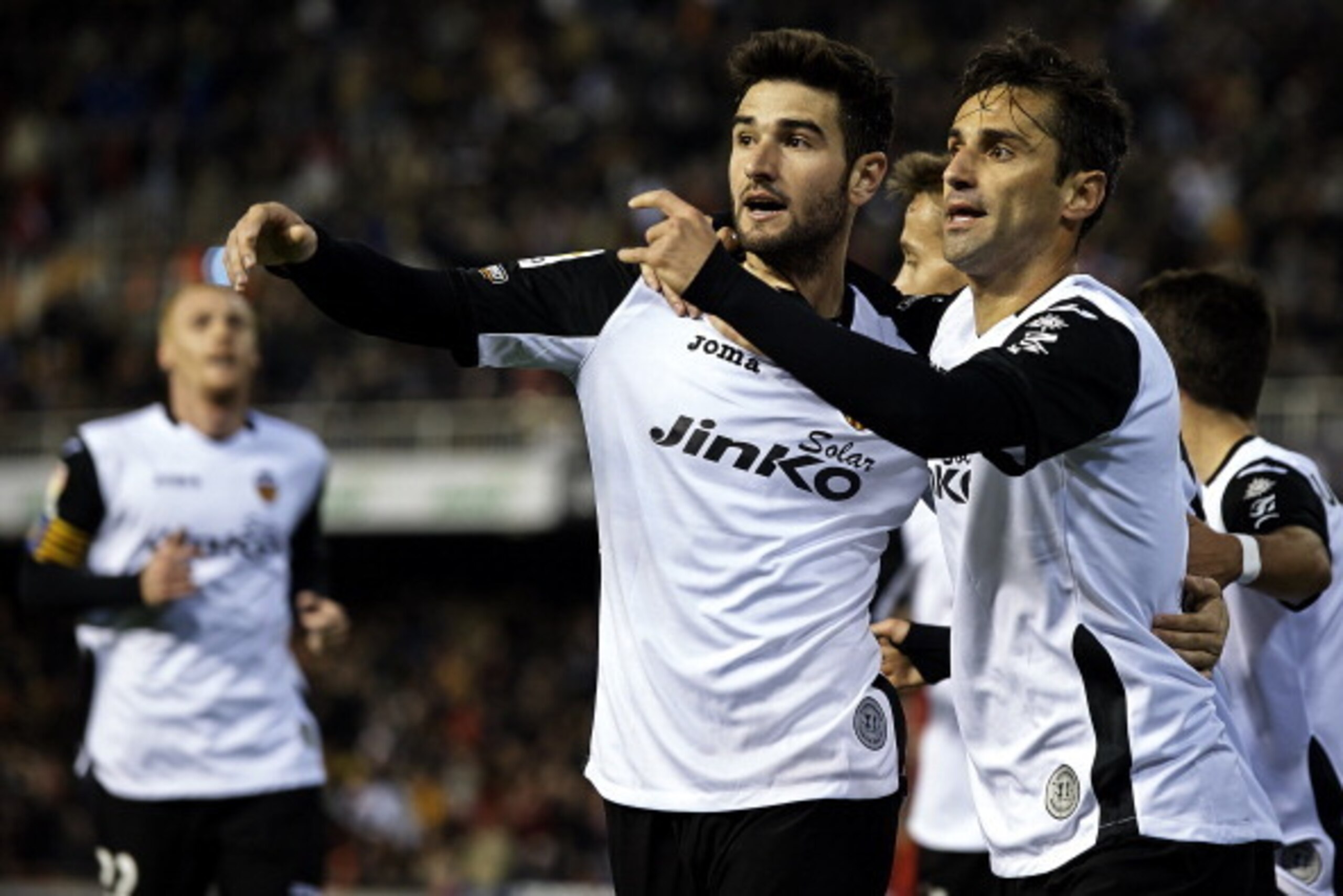 VALENCIA, SPAIN - DECEMBER 01:  Jonas (R) of Valencia celebrates after scoring with his teammate Antonio Barragan during the La Liga match between Valencia CF  and CA Osasuna at Estadio Mestalla on December 01, 2013 in Valencia, Spain.  (Photo by Manuel Q