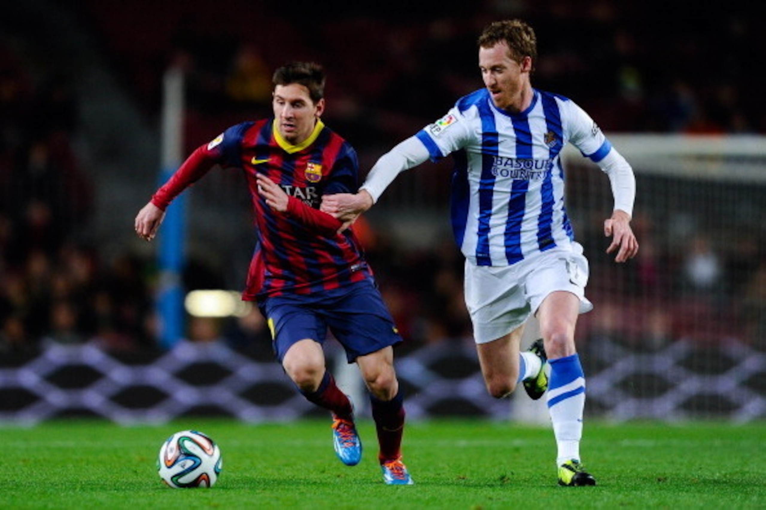 BARCELONA, SPAIN - FEBRUARY 05: Lionel Messi of FC Barcelona duels for the ball with David Zurutuza Veillet of Real Sociedad during the Copa del Rey Semi-Final first leg match between Barcelona and Real Sociedad at Camp Nou on February 5, 2014 in Barcelo BARCELONA, SPAIN - FEBRUARY 05: Lionel Messi of FC Barcelona duels for the ball with David Zurutuza Veillet of Real Sociedad during the Copa del Rey Semi-Final first leg match between Barcelona and Real Sociedad at Camp Nou on February 5, 2014 in Barcelo