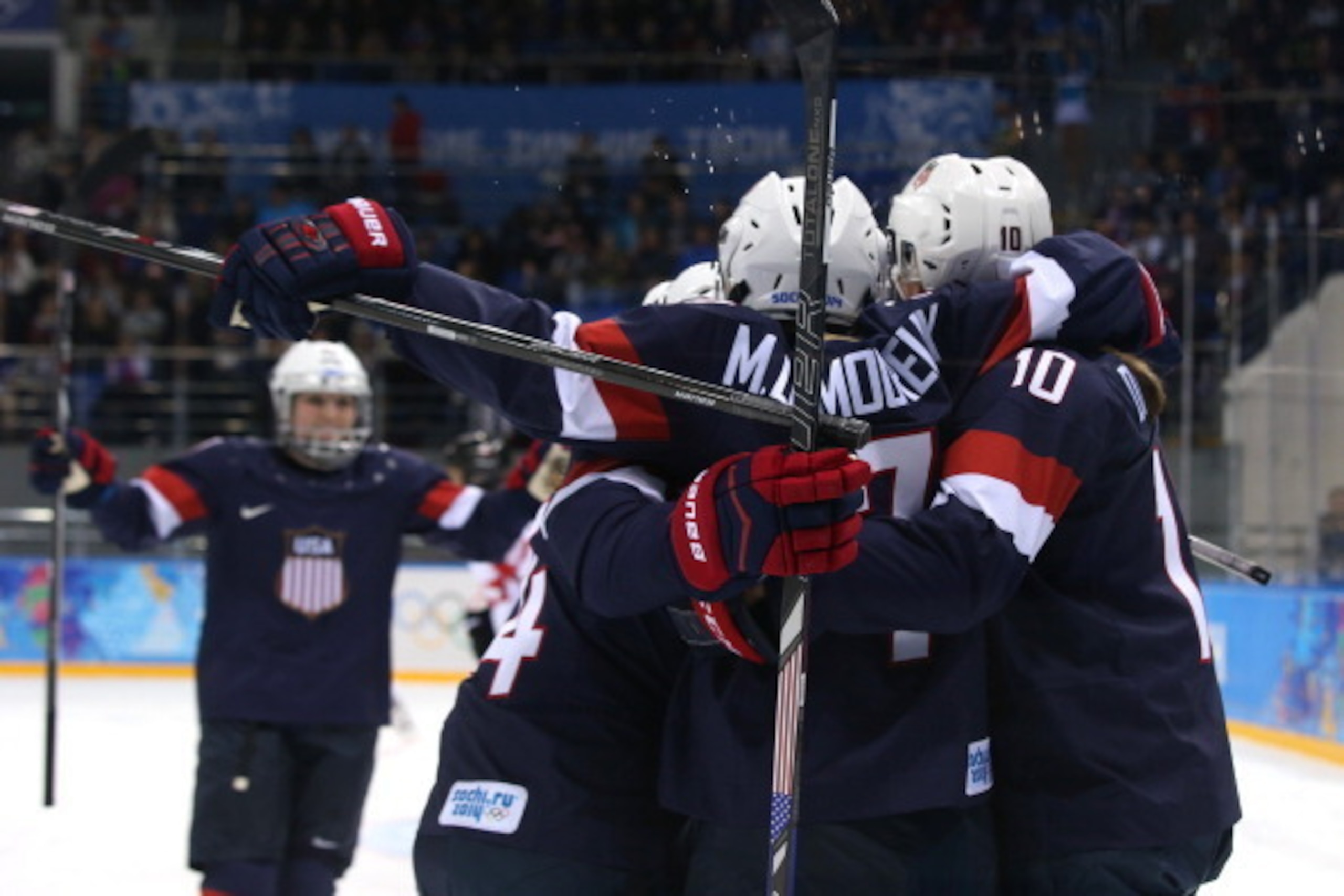 SOCHI, RUSSIA - FEBRUARY 10:  Monique Lamoureux #7 of United States celebrates after scoring a goal in the first period during the Women's Ice Hockey Preliminary Round Group A game against Switzerland on day three of the Sochi 2014 Winter Olympics at Shay