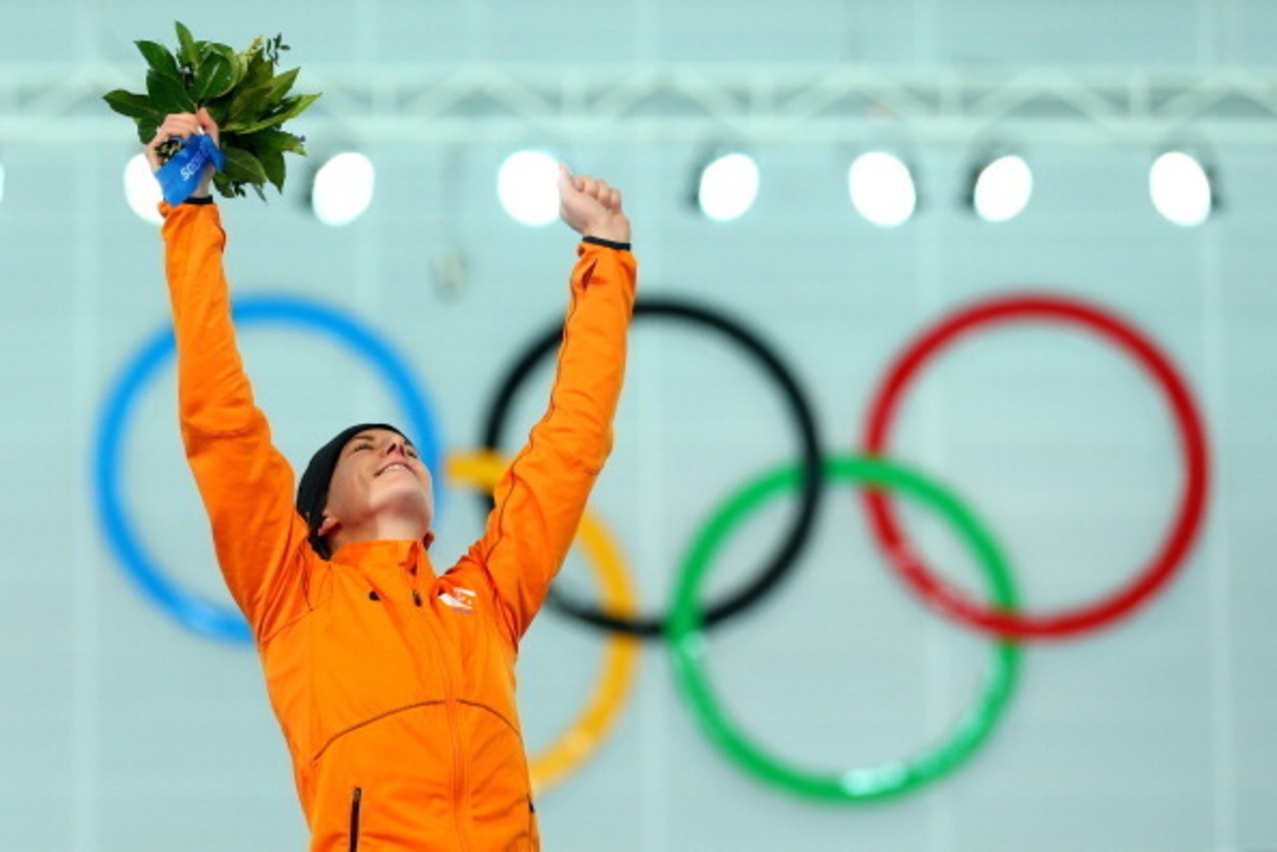 SOCHI, RUSSIA - FEBRUARY 09: Gold medalist Irene Wust of the Netherlands celebrates on the podium during the flower ceremony for the Women's 3000m Speed Skating event during day 2 of the Sochi 2014 Winter Olympics at Adler Arena Skating Center on Februar SOCHI, RUSSIA - FEBRUARY 09: Gold medalist Irene Wust of the Netherlands celebrates on the podium during the flower ceremony for the Women's 3000m Speed Skating event during day 2 of the Sochi 2014 Winter Olympics at Adler Arena Skating Center on Februar