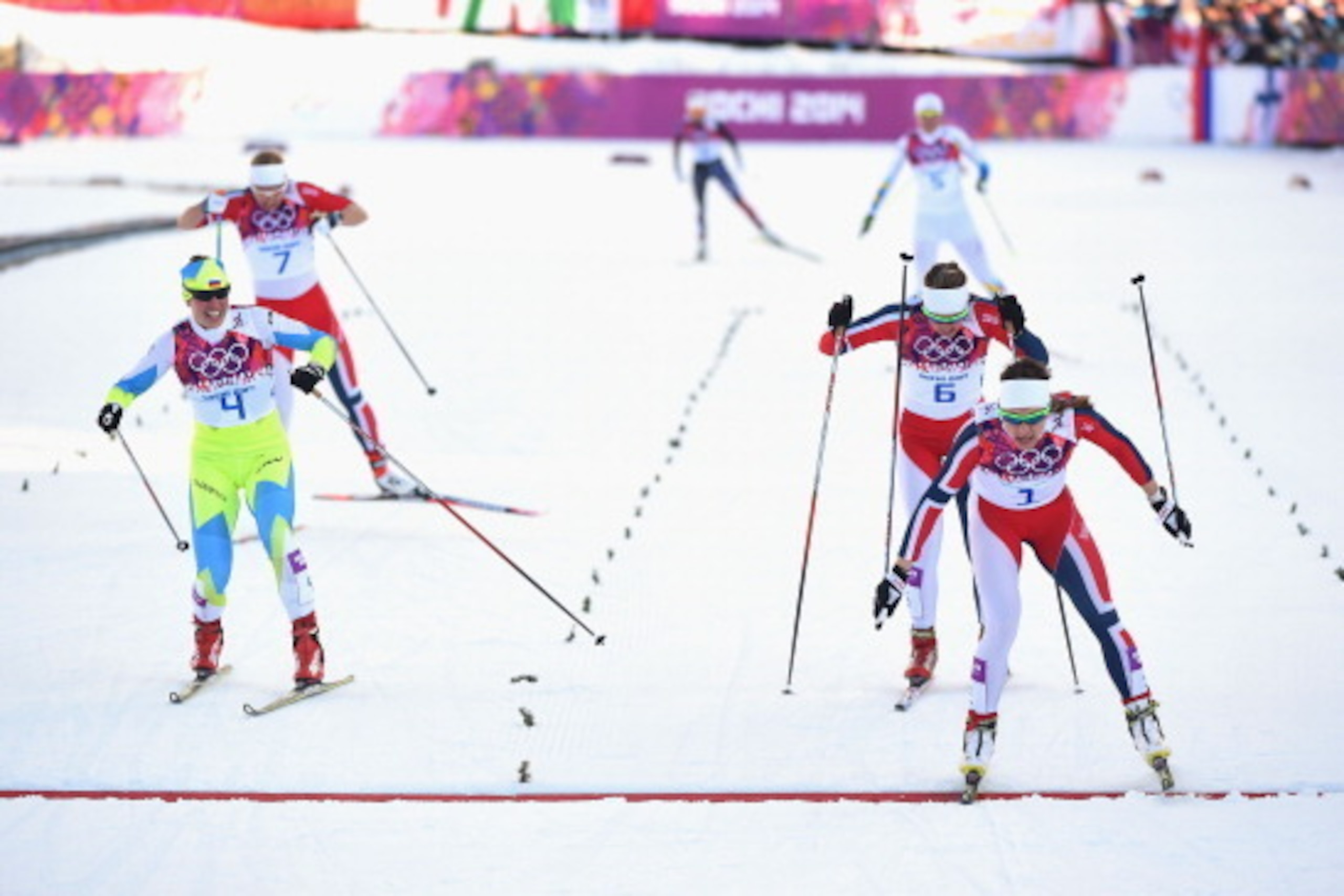 SOCHI, RUSSIA - FEBRUARY 11:  Maiken Caspersen Falla of Norway (R) crosses the finish line ahead of Vesna Fabjan of Slovenia (L) and Ingvild Flugstad Oestberg of Norway in the Finals of the Ladies' Sprint Free during day four of the Sochi 2014 Winter Olym