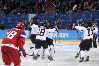 SOCHI, RUSSIA - FEBRUARY 11:  Ayaka Toko #4 of Japan celebrates with her teammates after scoring in the third period on Anna Prugova #1 of Russia during the Women's Ice Hockey Preliminary Round Group B game on day four of the Sochi 2014 Winter Olympics at