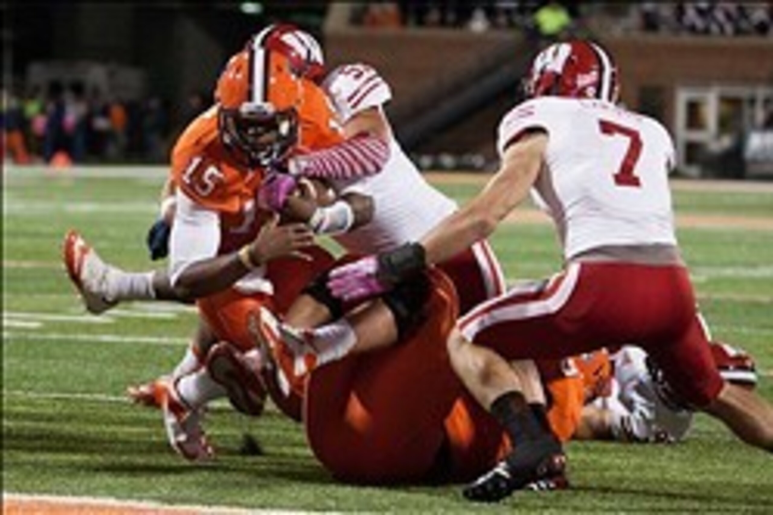 Oct 19, 2013; Champaign, IL, USA;  Illinois Fighting Illini quarterback Aaron Bailey (15) is tackled by Wisconsin Badgers linebacker Marcus Trotter (59) and safety Michael Caputo (7) during the third quarter of the game at Memorial Stadium. Wisconsin wins