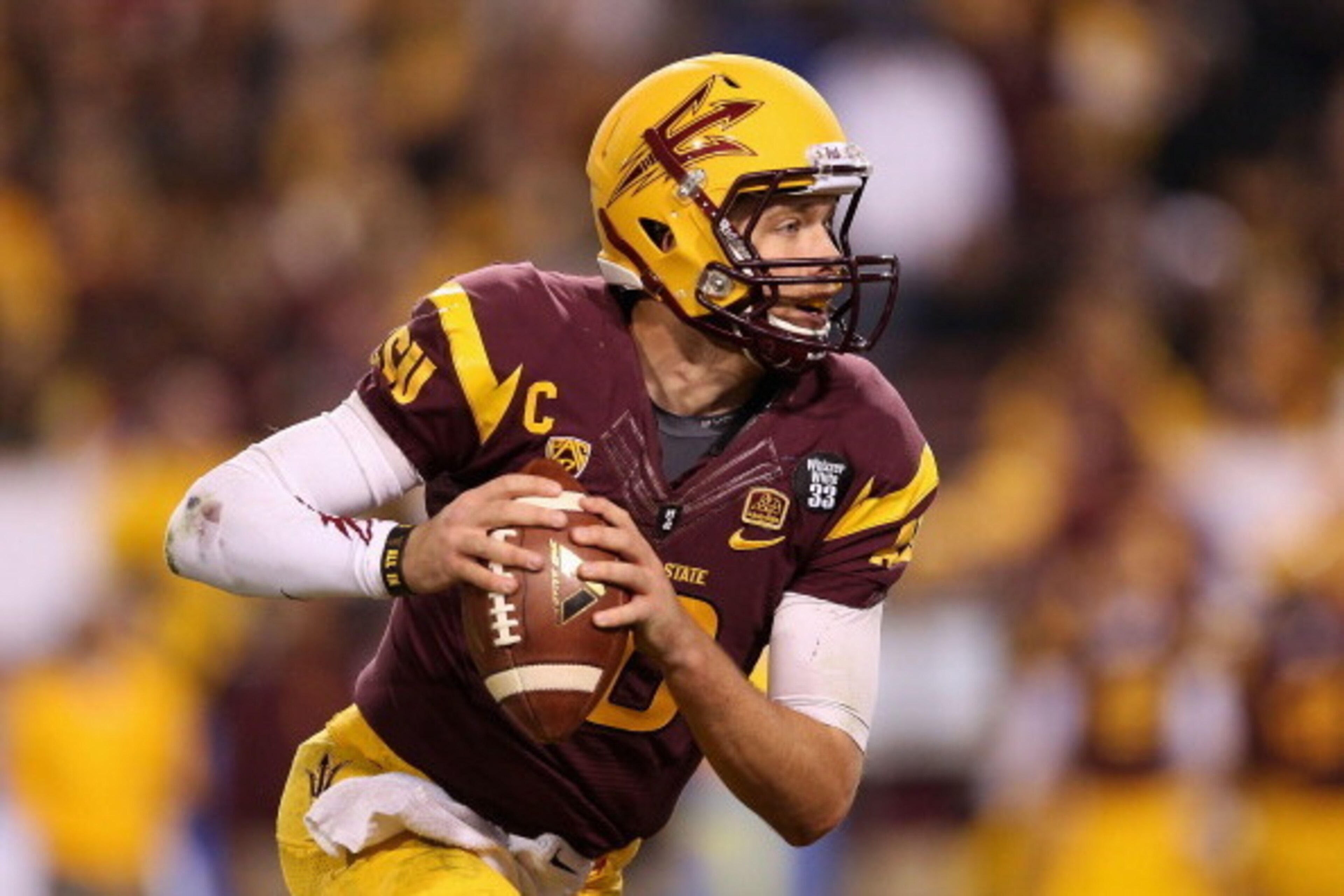 TEMPE, AZ - DECEMBER 07: Quarterback Taylor Kelly #10 of the Arizona State Sun Devils drops back to pass during the Pac 12 Championship game against the Stanford Cardinal at Sun Devil Stadium on December 7, 2013 in Tempe, Arizona. The Carindal defeated t TEMPE, AZ - DECEMBER 07: Quarterback Taylor Kelly #10 of the Arizona State Sun Devils drops back to pass during the Pac 12 Championship game against the Stanford Cardinal at Sun Devil Stadium on December 7, 2013 in Tempe, Arizona. The Carindal defeated t