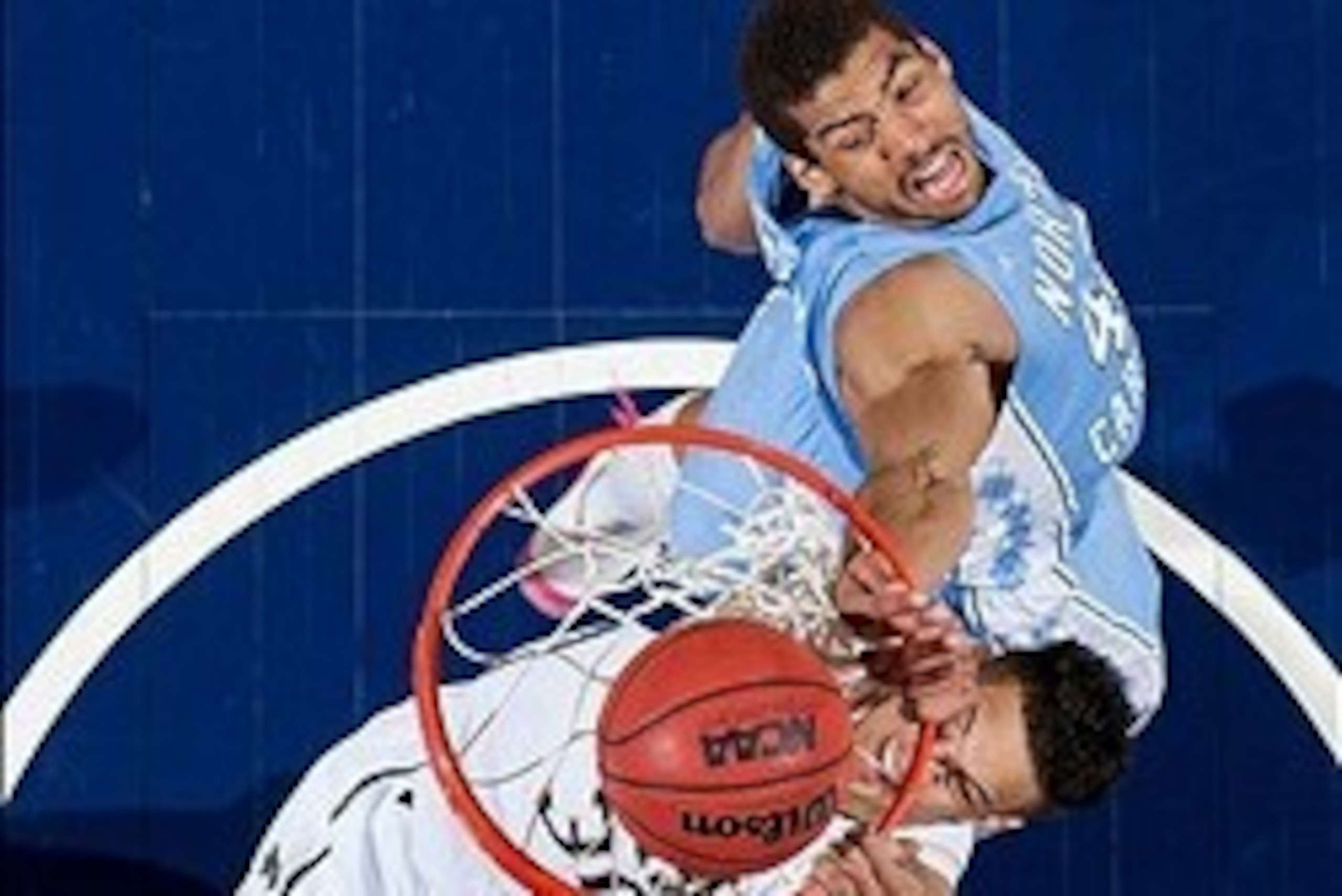 Feb 8, 2014; South Bend, IN, USA; Notre Dame Fighting Irish forward Zach Auguste (30) dunks as North Carolina Tar Heels forward James Michael McAdoo (43) defends in the first half at the Purcell Pavilion. North Carolina won 73-62. Mandatory Credit: Matt C