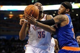 Feb 9, 2014; Oklahoma City, OK, USA; Oklahoma City Thunder small forward Kevin Durant (35) shoots the ball as New York Knicks small forward Carmelo Anthony (7) defends during the fourth quarter at Chesapeake Energy Arena. Mandatory Credit: Mark D. Smith-U