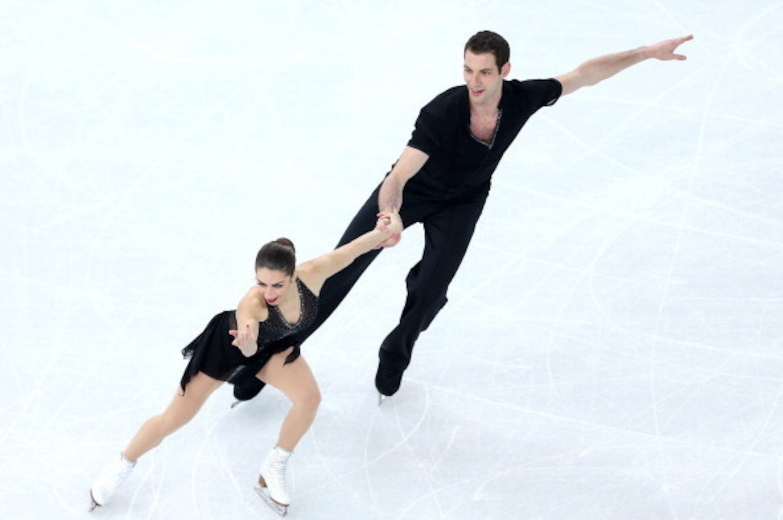 SOCHI, RUSSIA - FEBRUARY 11:  Marissa Castelli and Simon Shnapir of the United States compete during the Figure Skating Pairs Short Program on day four of the Sochi 2014 Winter Olympics at Iceberg Skating Palace on February 11, 2014 in Sochi, Russia.  (Ph
