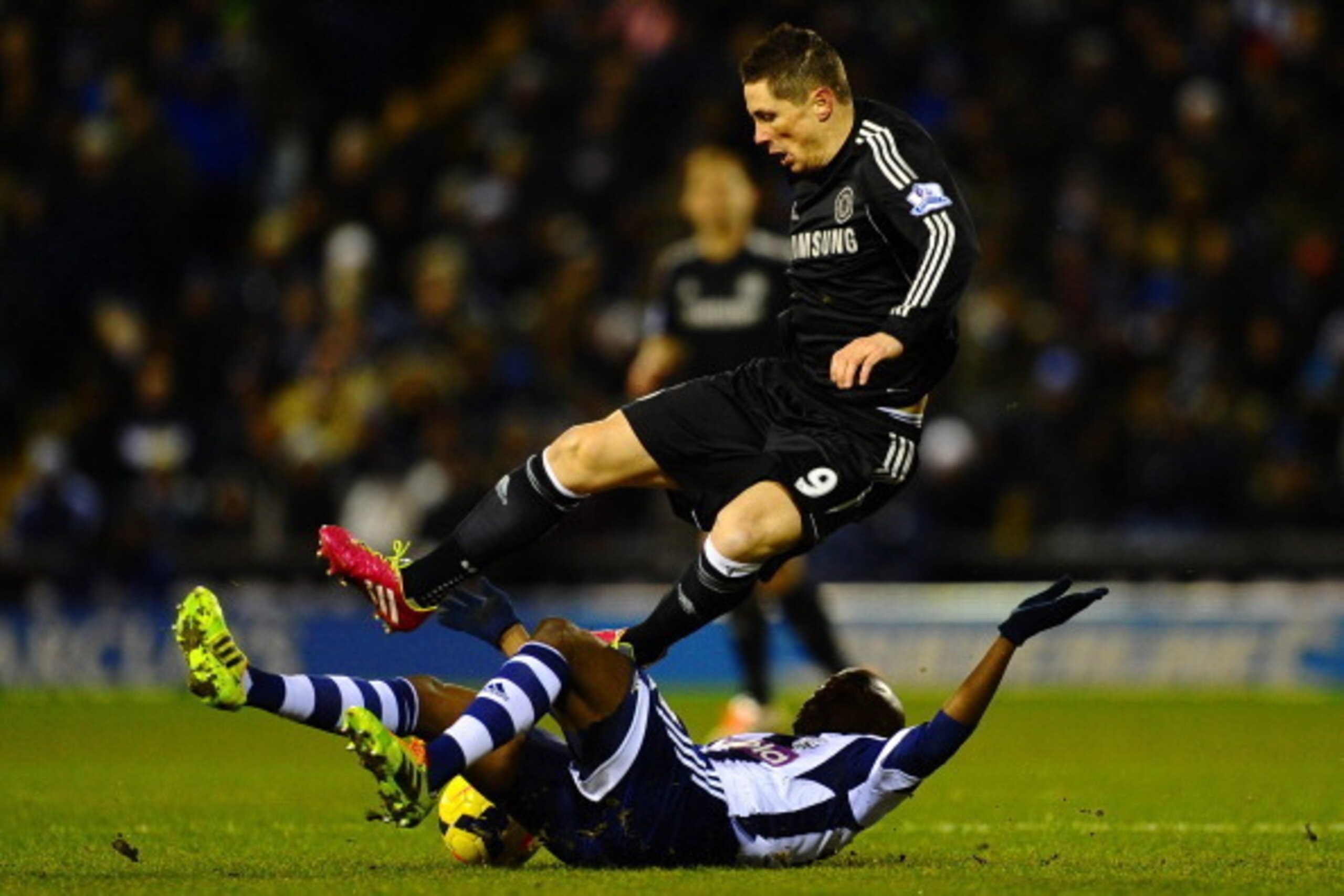 WEST BROMWICH, ENGLAND - FEBRUARY 11:  Youssuf Mulumbu of West Brom tackles Fernando Torres of Chelsea  during the Barclays Premier League match between West Bromwich Albion and Chelsea at The Hawthorns on February 11, 2014 in West Bromwich, England.  (Ph
