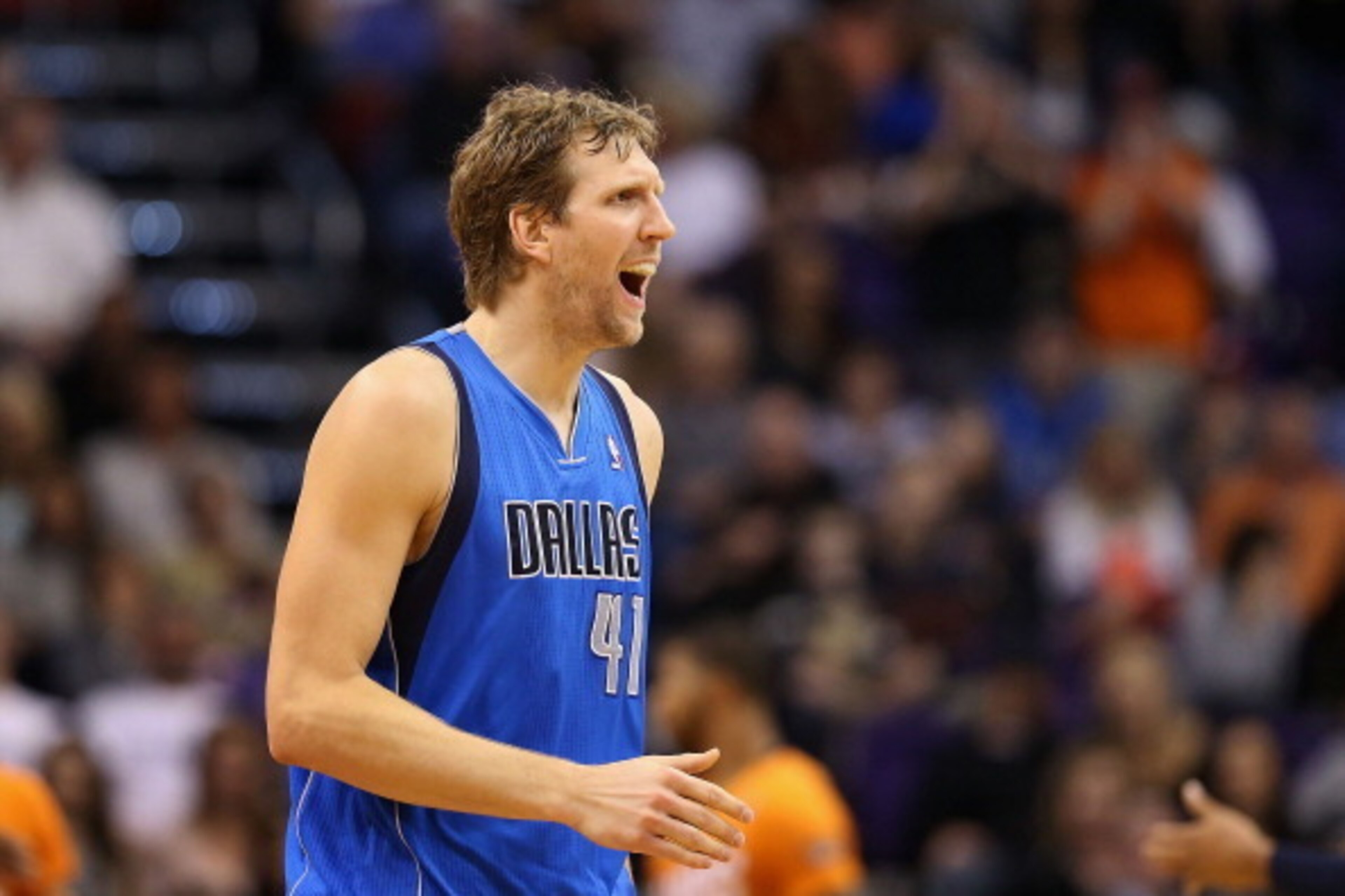 PHOENIX, AZ - JANUARY 17:  Dirk Nowitzki #41 of the Dallas Mavericks reacts after scoring against the Phoenix Suns during the second half of the NBA game at US Airways Center on January 17, 2014 in Phoenix, Arizona.  The Mavericks defeated the Suns 110-10