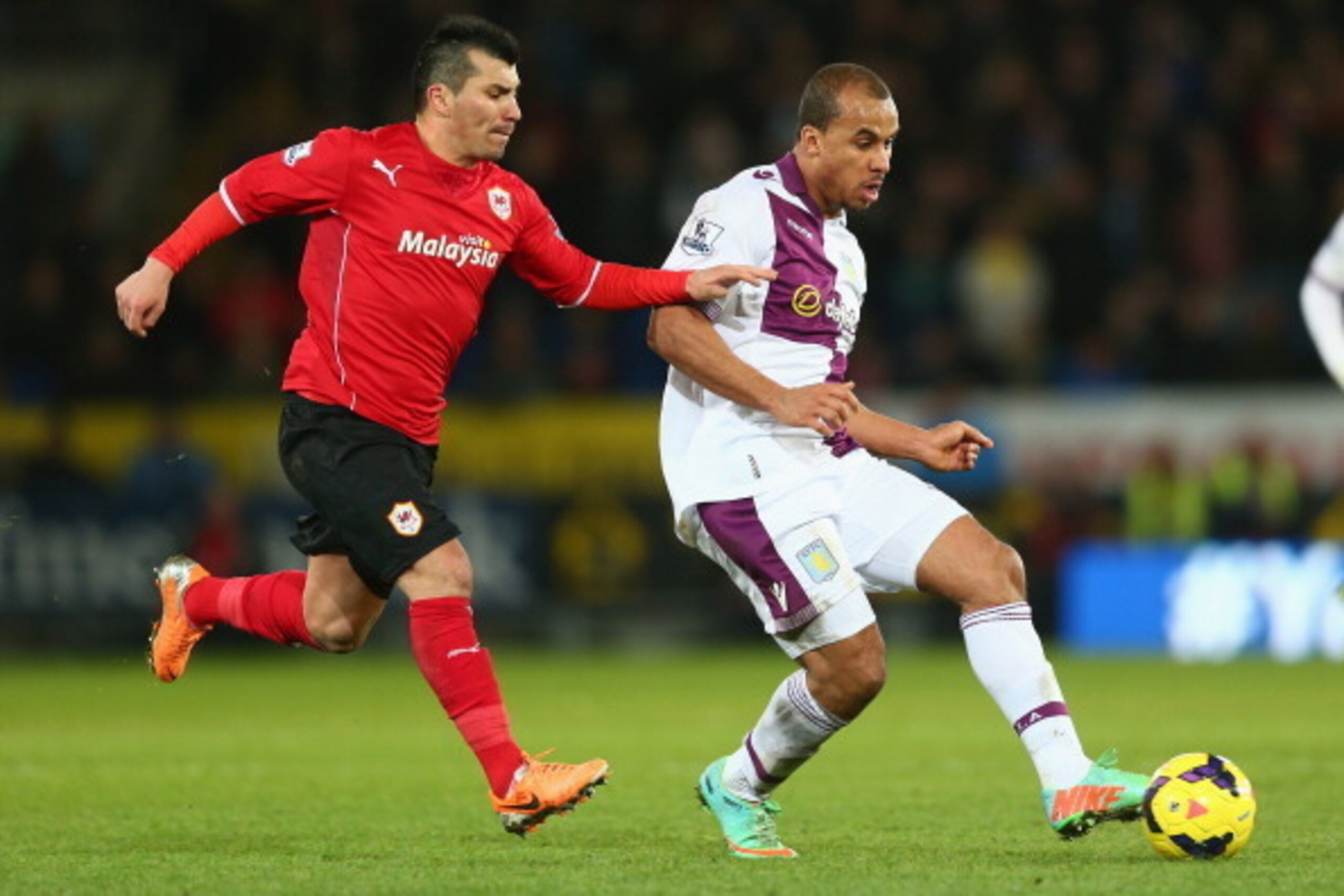 CARDIFF, WALES - FEBRUARY 11:  Gary Medel (L) of Cardiff City tracks Gabriel Agbonlahor (R) of Aston Villa during the Barclays Premier League match between Cardiff City and Aston Villa at the Cardiff City Stadium on February 11, 2014 in Cardiff, Wales.  (