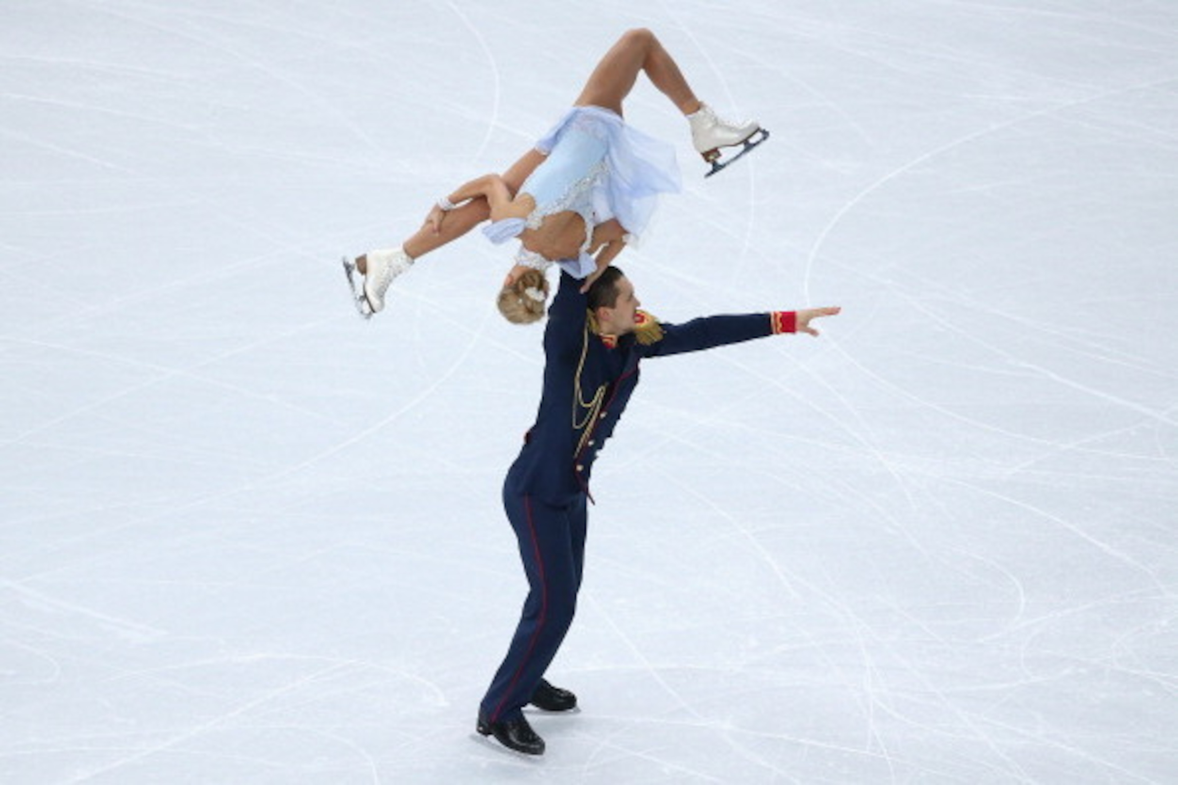 SOCHI, RUSSIA - FEBRUARY 06:  Tatiana Volosozhar and Maxim Trankov of Russia compete in the Figure Skating Pairs Short Program during the Sochi 2014 Winter Olympics at Iceberg Skating Palace  on February 6, 2014 in Sochi, Russia.  (Photo by Robert Cianflo