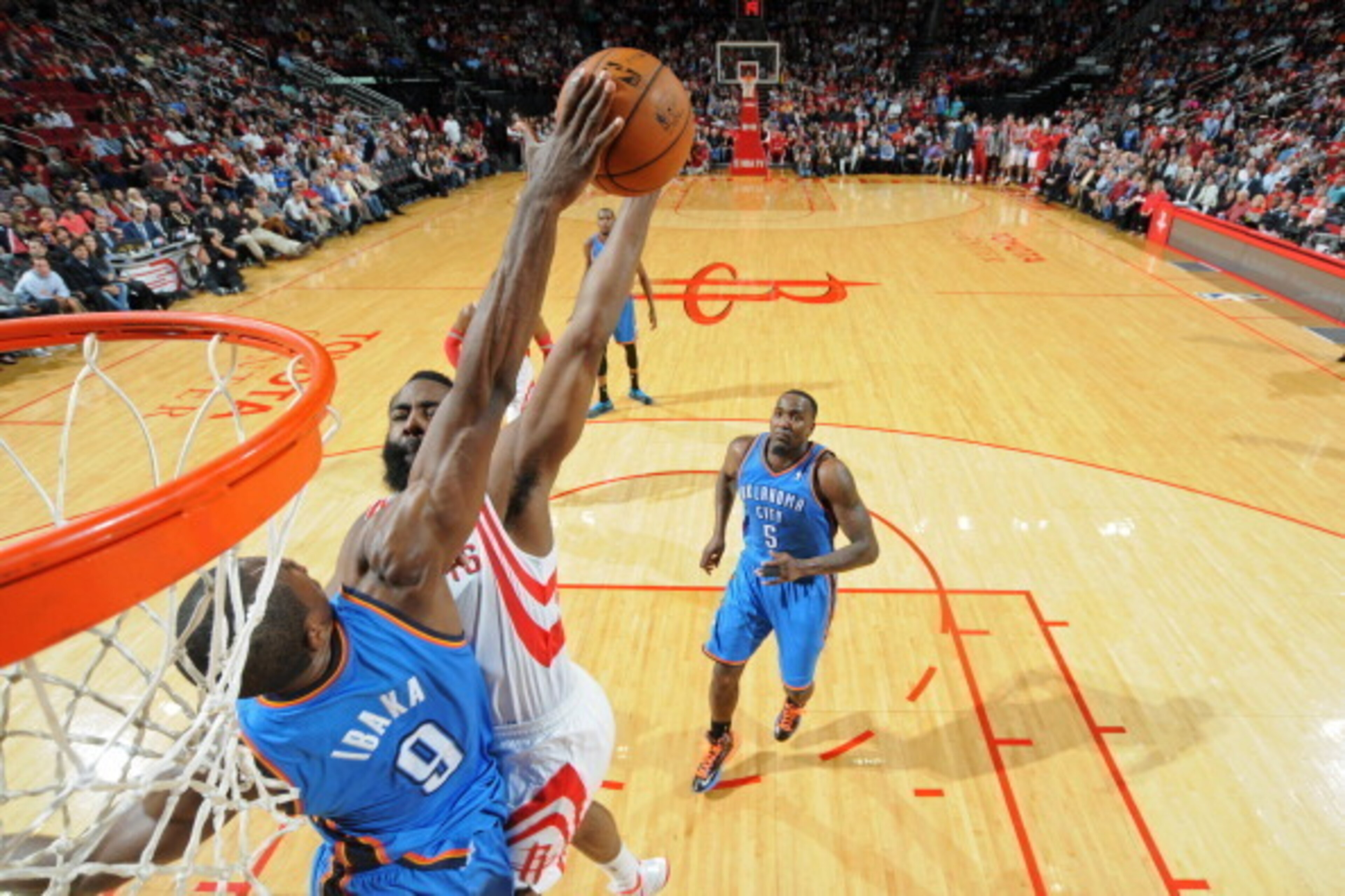 HOUSTON, TX - JANUARY 16:  James Harden #13 of the Houston Rockets gets his shot blocked by Serge Ibaka #9 of the Oklahoma City Thunder on January 16, 2014 at the Toyota Center in Houston, Texas. NOTE TO USER: User expressly acknowledges and agrees that, 