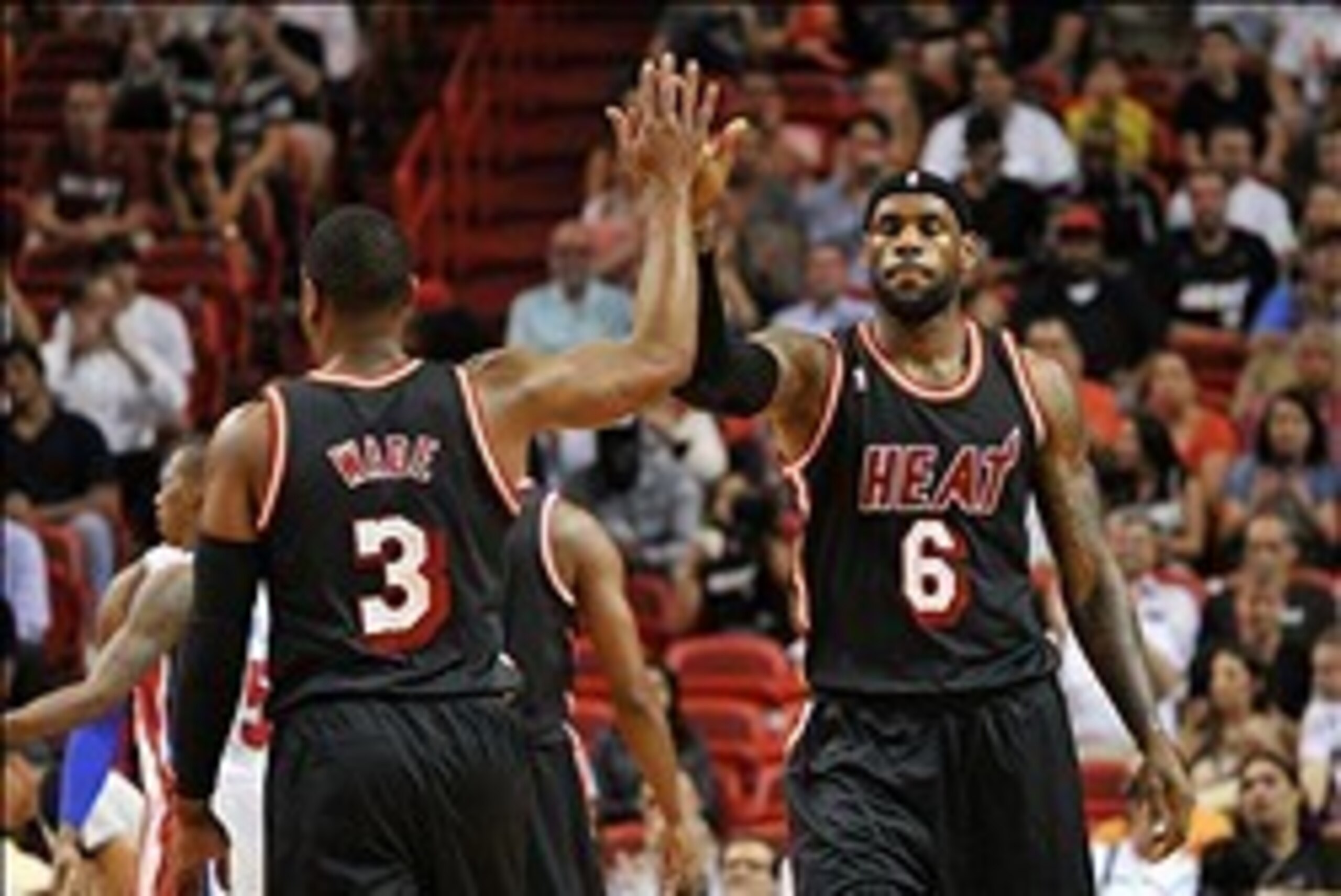 Feb 3, 2014; Miami, FL, USA; Miami Heat small forward LeBron James (right) high fives teammate shooting guard Dwyane Wade (left) during the first half against the Detroit Pistons at American Airlines Arena. Mandatory Credit: Steve Mitchell-USA TODAY Sport