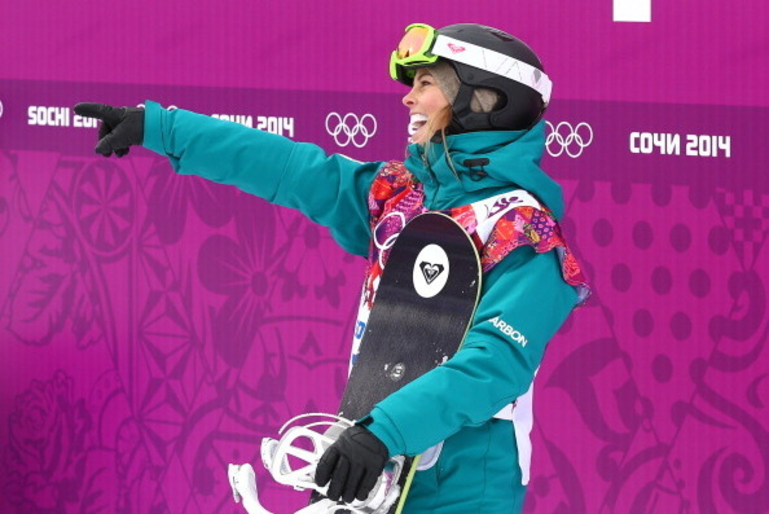 SOCHI, RUSSIA - FEBRUARY 09:  Torah Bright of Australia waves to the crowd as she waits to receive her score in her Women's Snowboard Slopestyle Finals during day two of the Sochi 2014 Winter Olympics at Rosa Khutor Extreme Park on February 9, 2014 in Soc