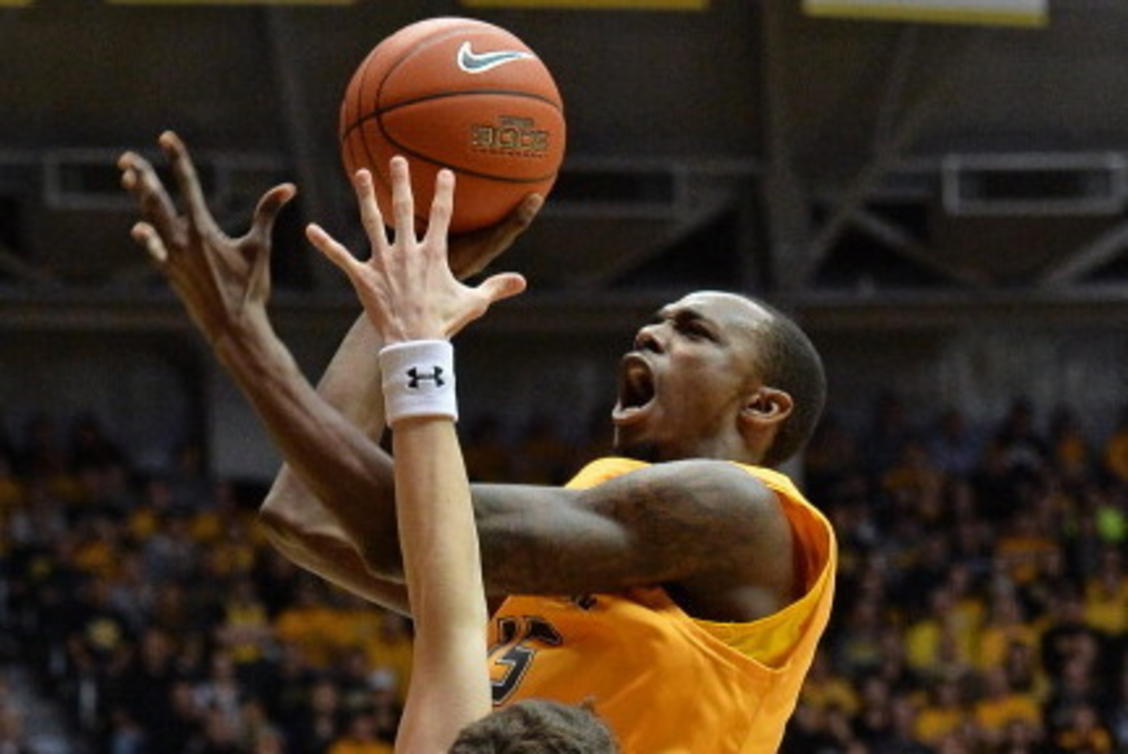 WICHITA, KS - FEBRUARY 11: Guard Nick Wiggins #15 of the Wichita State Shockers puts up a shot against guard Tyler Smithpeters #21 of the Southern Illinois Salukis during the first half on February 11, 2014 at Charles Koch Arena in Wichita, Kansas. (Ph WICHITA, KS - FEBRUARY 11: Guard Nick Wiggins #15 of the Wichita State Shockers puts up a shot against guard Tyler Smithpeters #21 of the Southern Illinois Salukis during the first half on February 11, 2014 at Charles Koch Arena in Wichita, Kansas. (Ph