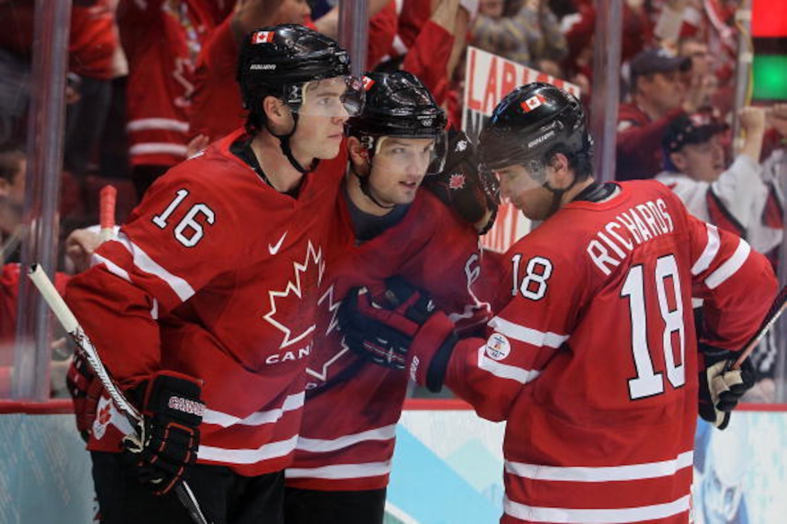 VANCOUVER, BC - FEBRUARY 23:  Rick Nash #61, Jonathan Toews #16 and Michael Richards #18 of Canada celebrate after a goal against Germany during the ice hockey Men's Qualification Playoff game between Germany and Canada on day 12 of the Vancouver 2010 Win