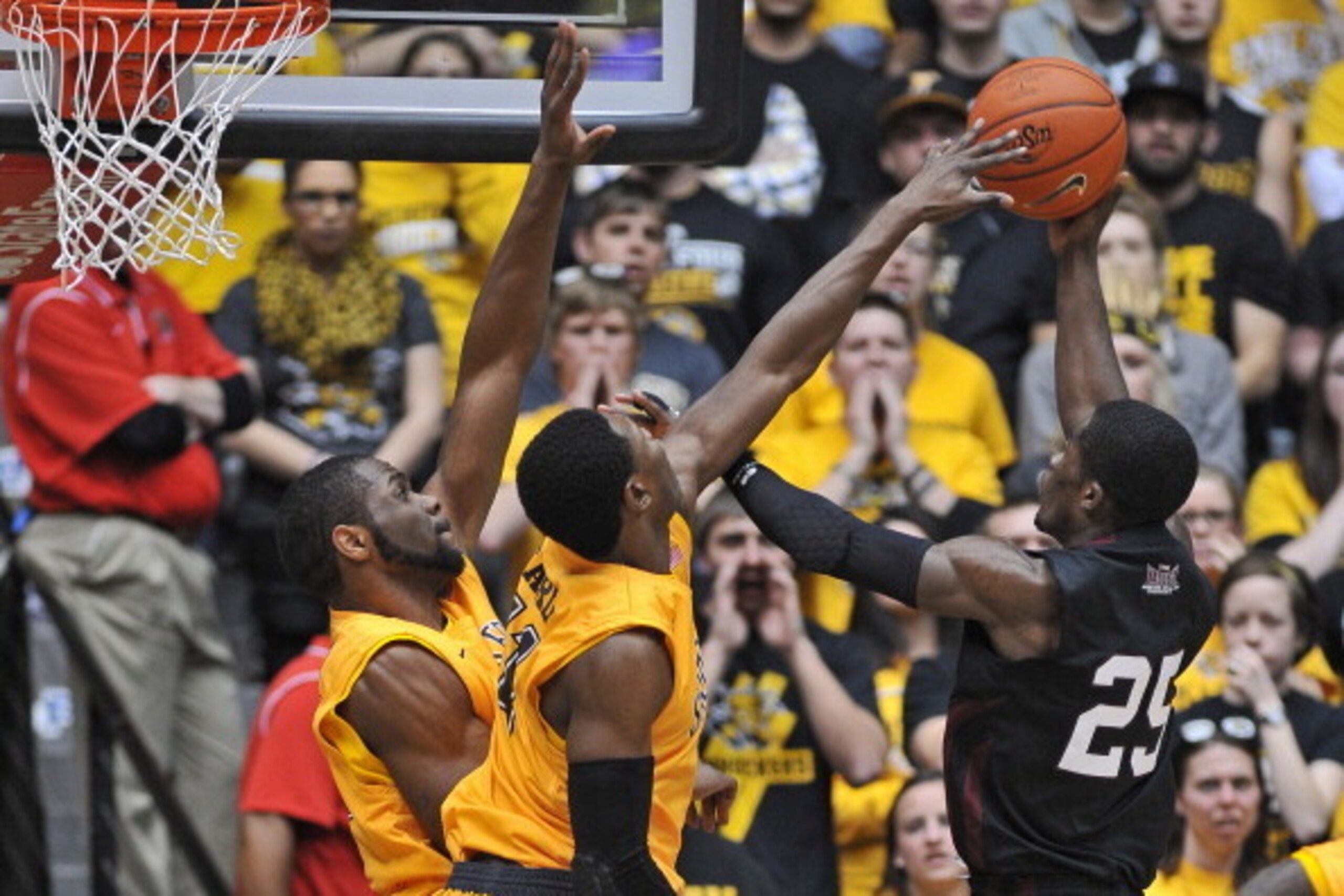 WICHITA, KS - FEBRUARY 11: Forward Cleanthony Early #11 of the Wichita State Shockers blocks the shot of guard Anthony Beane #25 of the Southern Illinois Salukis during the second half on February 11, 2014 at Charles Koch Arena in Wichita, Kansas. Wichi WICHITA, KS - FEBRUARY 11: Forward Cleanthony Early #11 of the Wichita State Shockers blocks the shot of guard Anthony Beane #25 of the Southern Illinois Salukis during the second half on February 11, 2014 at Charles Koch Arena in Wichita, Kansas. Wichi