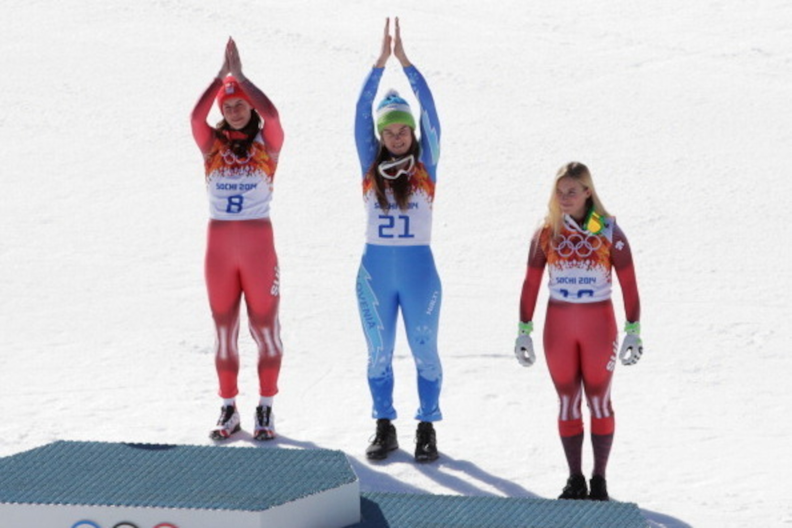 SOCHI, RUSSIA - FEBRUARY 12: (L-R) Gold medalist Dominique Gisin of Switzerland, gold medalist Tina Maze of Slovenia and bronze medalist Lara Gut of Switzerland celebrate on the podium during the flower ceremony for during the Alpine Skiing Women's Downhi