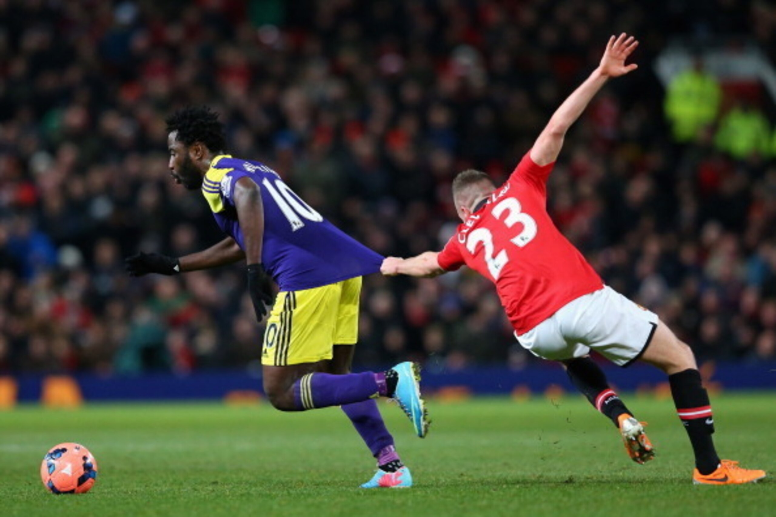 MANCHESTER, ENGLAND - JANUARY 05: Tom Cleverley of Manchester United grabs the shirt of Wilfried Bony of Swansea City during the FA Cup with Budweiser Third round match between Manchester United and Swansea City at Old Trafford on January 5, 2014 in Manc MANCHESTER, ENGLAND - JANUARY 05: Tom Cleverley of Manchester United grabs the shirt of Wilfried Bony of Swansea City during the FA Cup with Budweiser Third round match between Manchester United and Swansea City at Old Trafford on January 5, 2014 in Manc