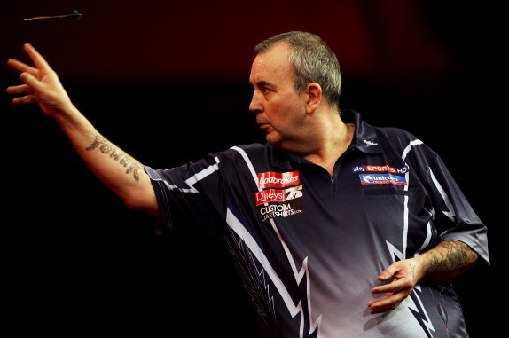LONDON, ENGLAND - JANUARY 1: Phil Taylor of England in action against Michael van Gerwen of the Netherlands during the final of the 2013 Ladbrokes.com World Darts Championship at the Alexandra Palace on January 1, 2013 in London, England. (Photo by Ben Ho
