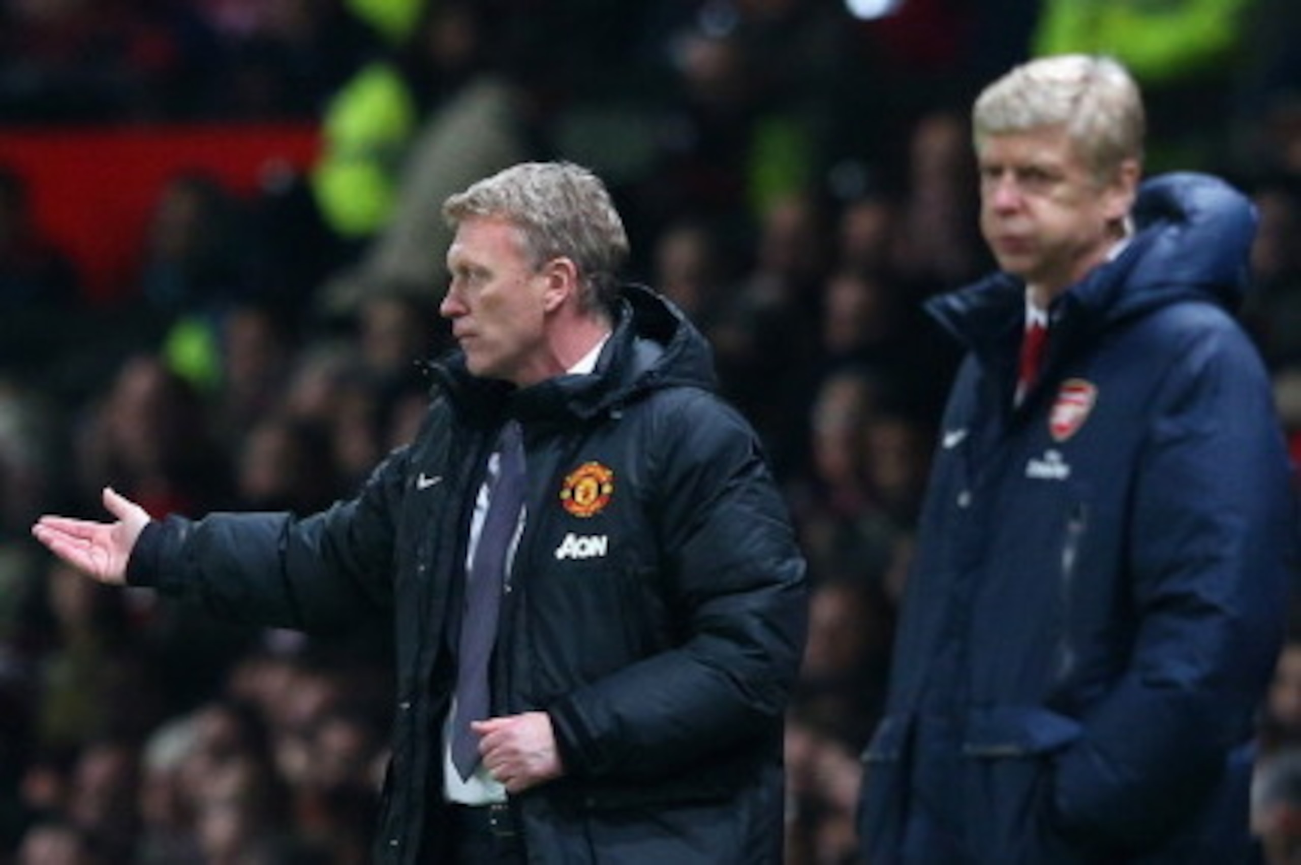 MANCHESTER, ENGLAND - NOVEMBER 10:  Manchester United Manager David Moyes reacts as Arsenal Manager Arsene Wenger looks on during the Barclays Premier League match between Manchester United and Arsenal at Old Trafford on November 10, 2013 in Manchester, E