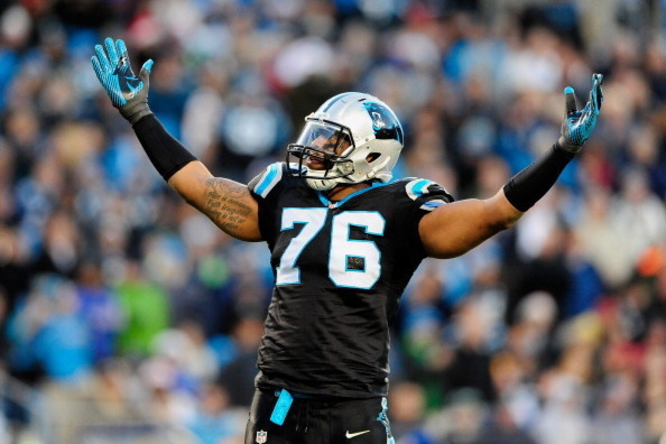 CHARLOTTE, NC - DECEMBER 15:  Greg Hardy #76 of the Carolina Panthers tells the fans to cheer against the New York Jets during play at Bank of America Stadium on December 15, 2013 in Charlotte, North Carolina.  (Photo by Grant Halverson/Getty Images)