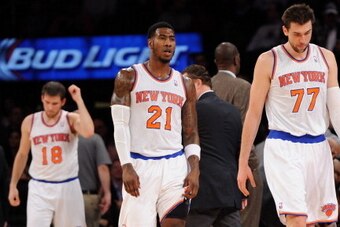 NEW YORK, NY - DECEMBER 16:  Andrea Bargnani #77, Iman Shumpert #21 and Beno Udrih #18 of the New York Knicks walk on to the court following a timeout during the fourth quarter against the Washington Wizards at Madison Square Garden on December 16, 2013 i