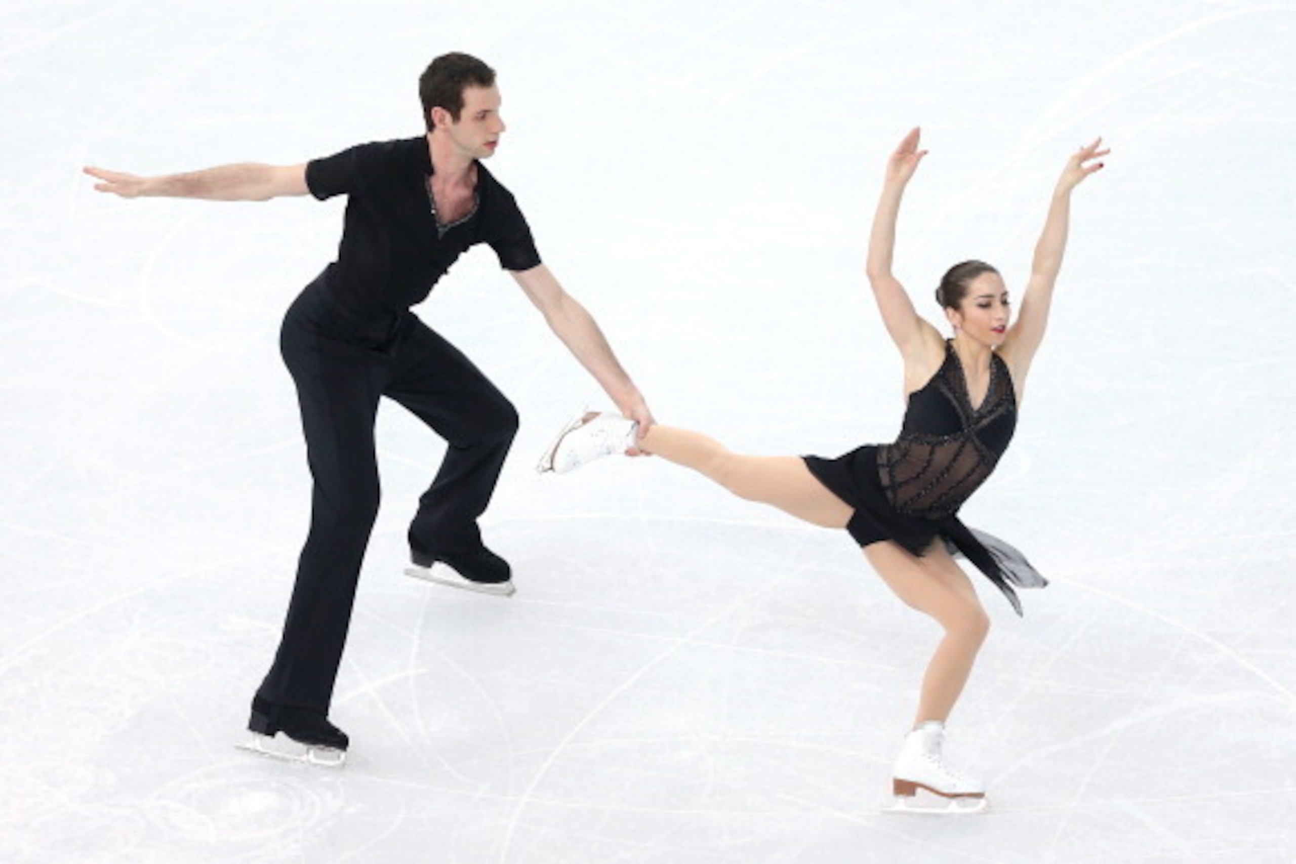 SOCHI, RUSSIA - FEBRUARY 11:  Marissa Castelli and Simon Shnapir of the United States compete during the Figure Skating Pairs Short Program on day four of the Sochi 2014 Winter Olympics at Iceberg Skating Palace on February 11, 2014 in Sochi, Russia.  (Ph
