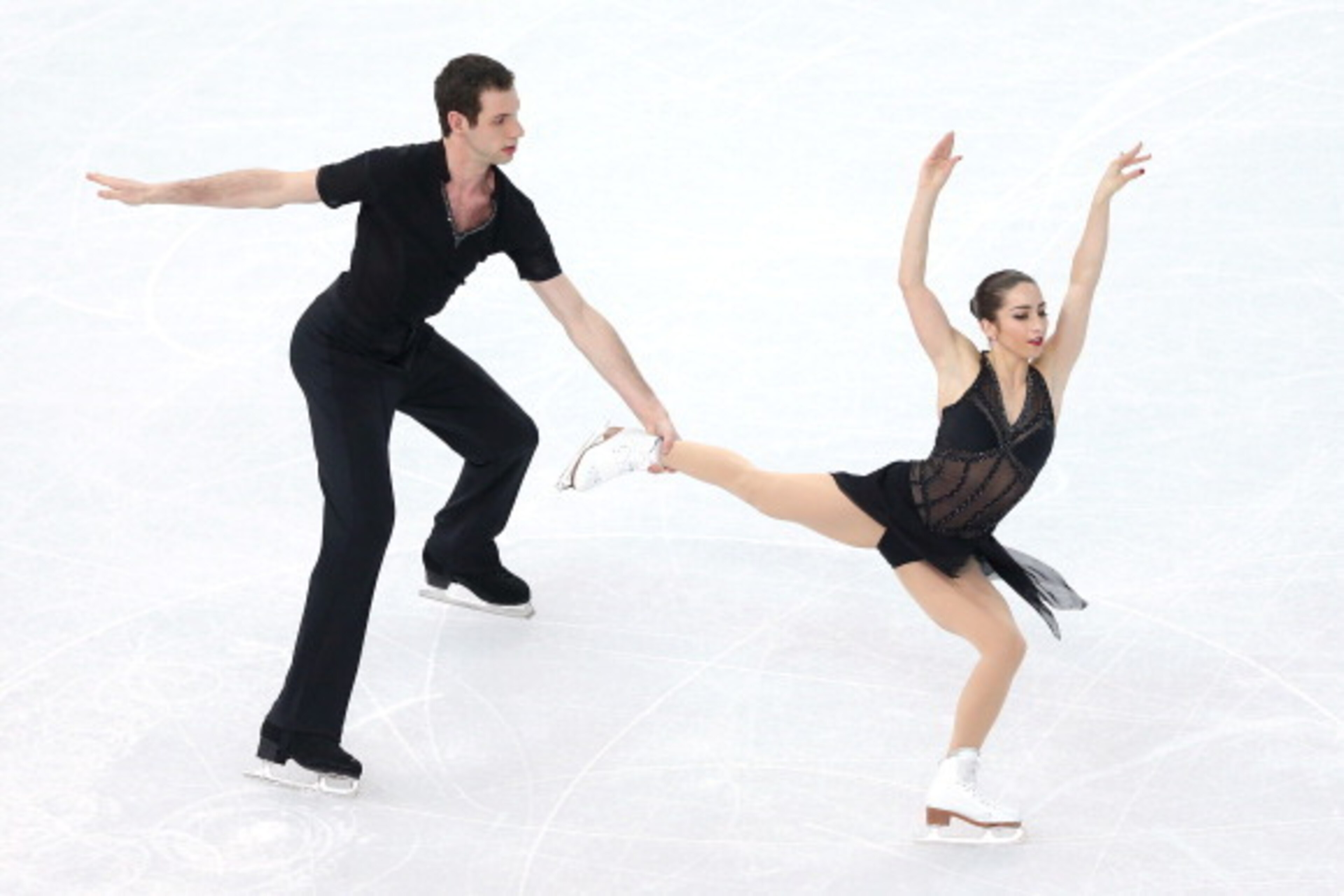 SOCHI, RUSSIA - FEBRUARY 11:  Marissa Castelli and Simon Shnapir of the United States compete during the Figure Skating Pairs Short Program on day four of the Sochi 2014 Winter Olympics at Iceberg Skating Palace on February 11, 2014 in Sochi, Russia.  (Ph