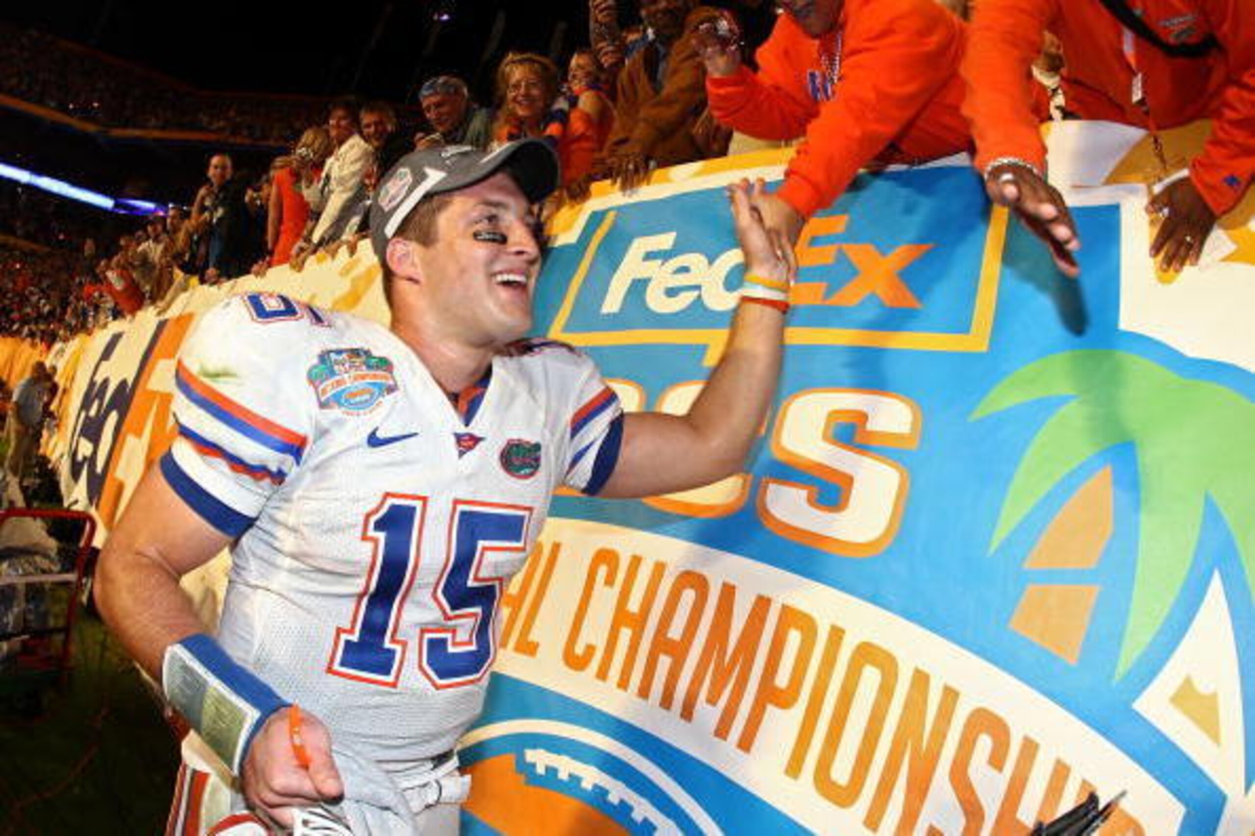 MIAMI - JANUARY 08:  Quarterback Tim Tebow #15 of the Florida Gators celebrates with fans after defeating the Oklahoma Sooners in the FedEx BCS National Championship Game at Dolphin Stadium on January 8, 2009 in Miami, Florida. The Gators won the game by 