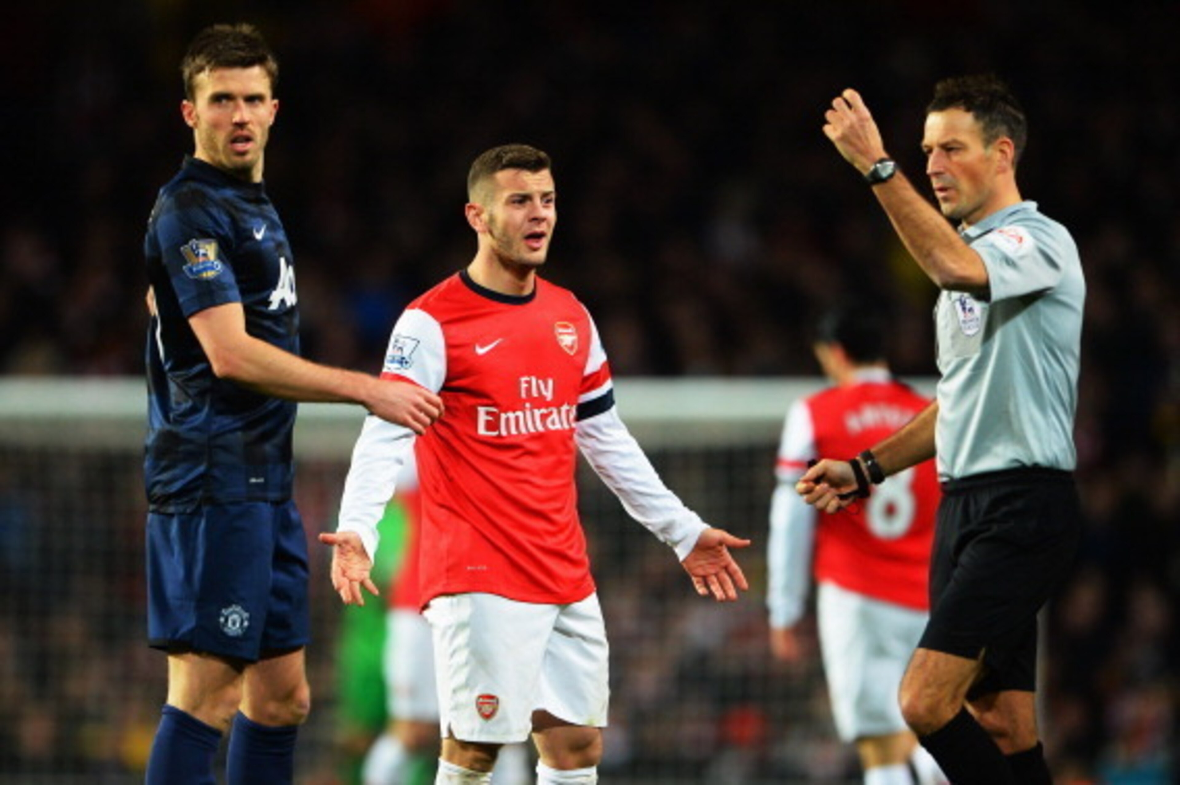 LONDON, ENGLAND - FEBRUARY 12:  Jack Wilshere (C) of Arsenal appeals to match referee Mark Clattenburg during the Barclays Premier League match between Arsenal and Manchester United at the Emirates Stadium on February 12, 2014 in London, England.  (Photo 